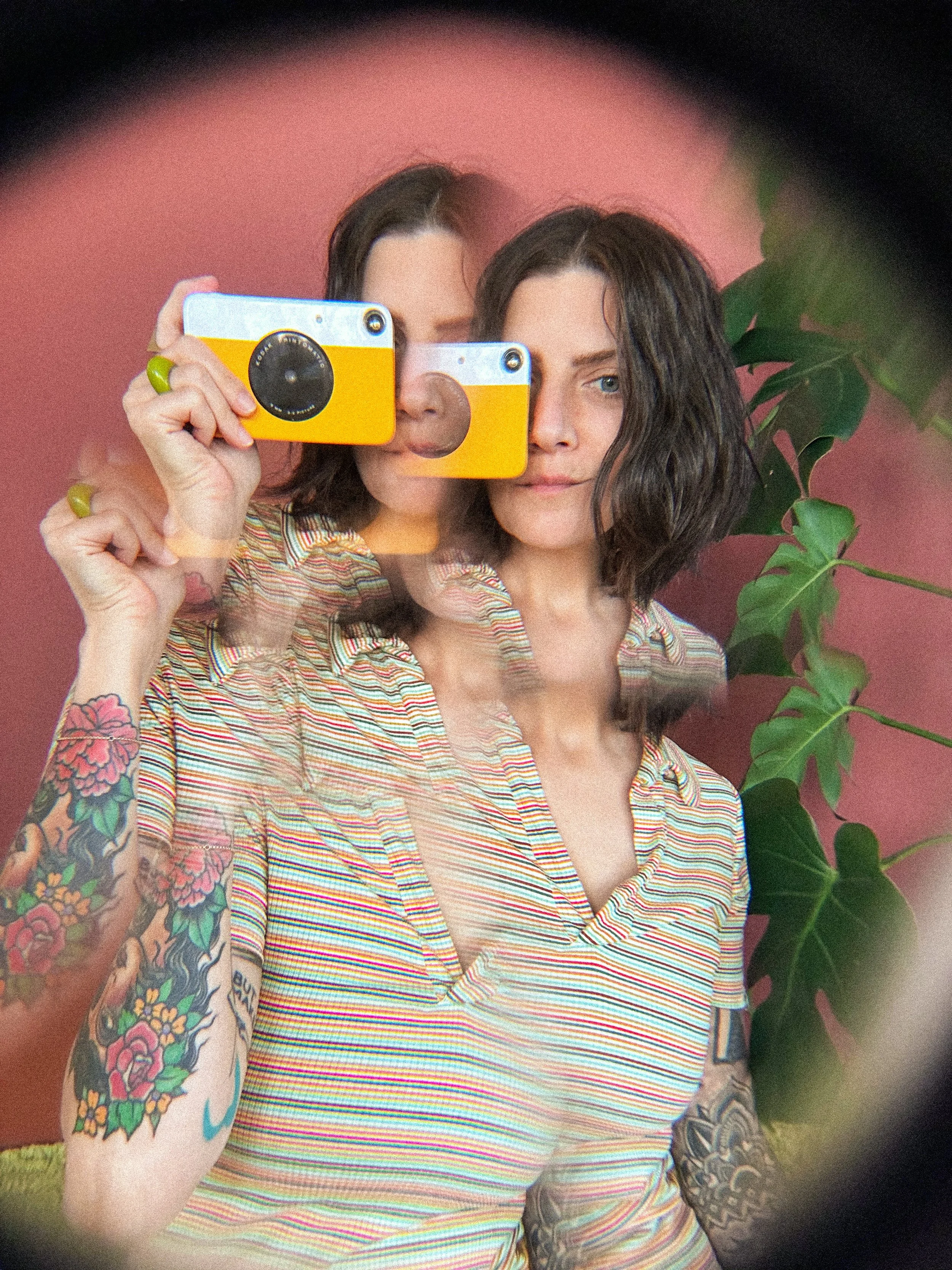 Photo of founder of DoGoodBiz Creative Studio, Natalie Brite, holding a polaroid camera