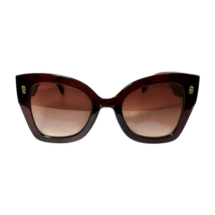 Red and black oversized sunglasses with gradient lenses on a white background.
