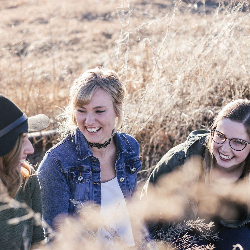 3 woman in a farm field at a workshop with horses near Woodbridge, Ontario.