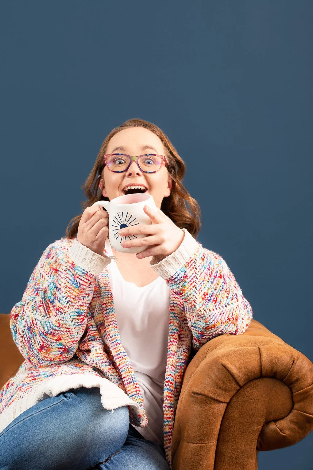 Brand and web designer Lauren Bird, founder of Lauren Bird Design, laughing with a coffee mug in hand