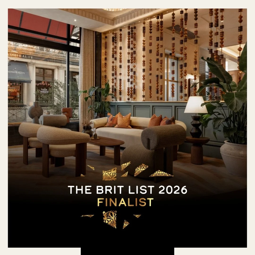 Trafalgar St James Street Hotel is a finalist in the Brit List Awards 2026. Elegant hotel lobby with large windows, modern furniture, green plants, and decorative wooden beads hanging from the ceiling.