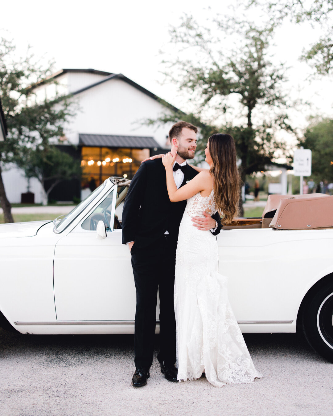 Your getaway car takes sunset photos to the next level, especially when you get the reception barn glowing in the back! ​​​​​​​​
​​​​​​​​
Photography: @sarahblazephotog​​​​​​​​
Planning: @eventsbyleslietx​​​​​​​​
Beauty: @lolabeautyatx​​​​​​​​
​​​​​​