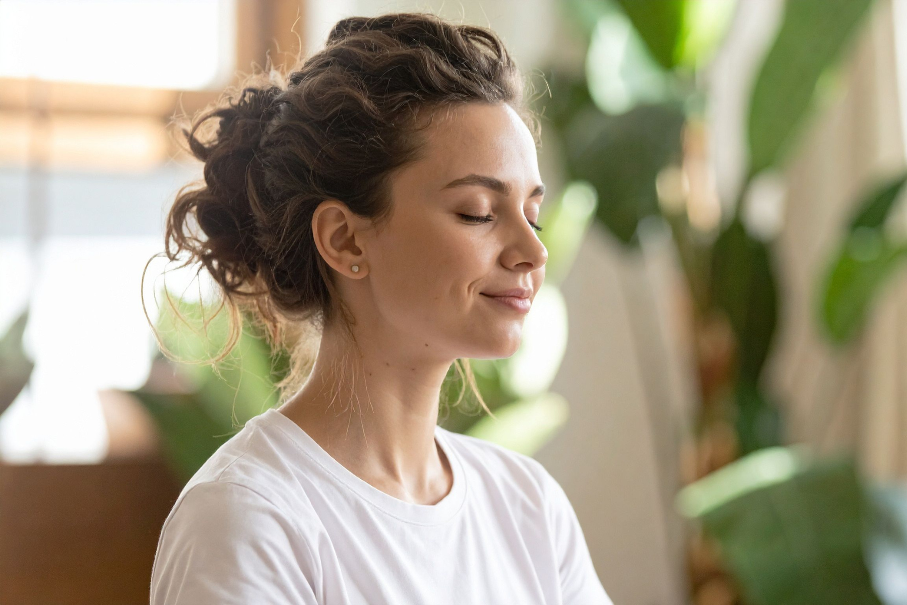 A woman closes her eyes, practicing mindfulness
