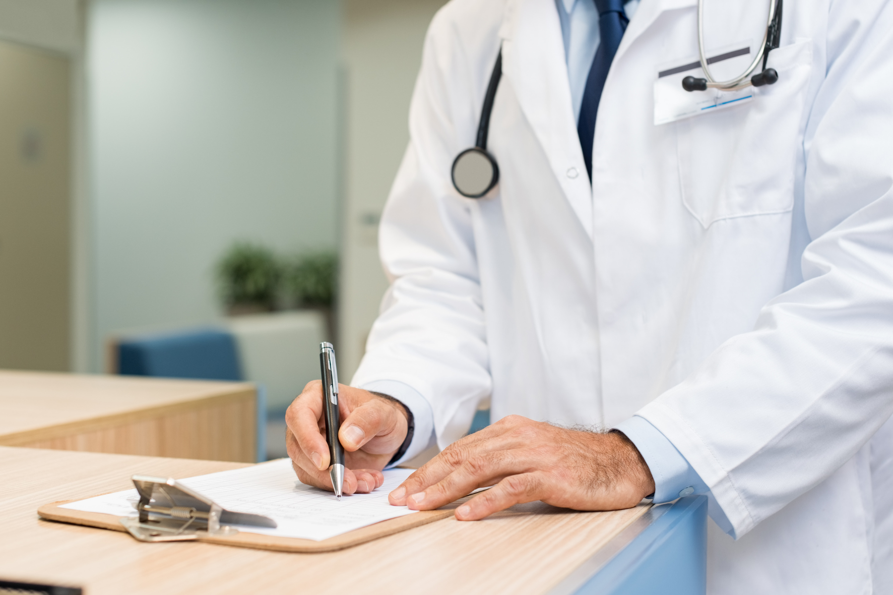 A psychiatrist fills out a prescription for a patient