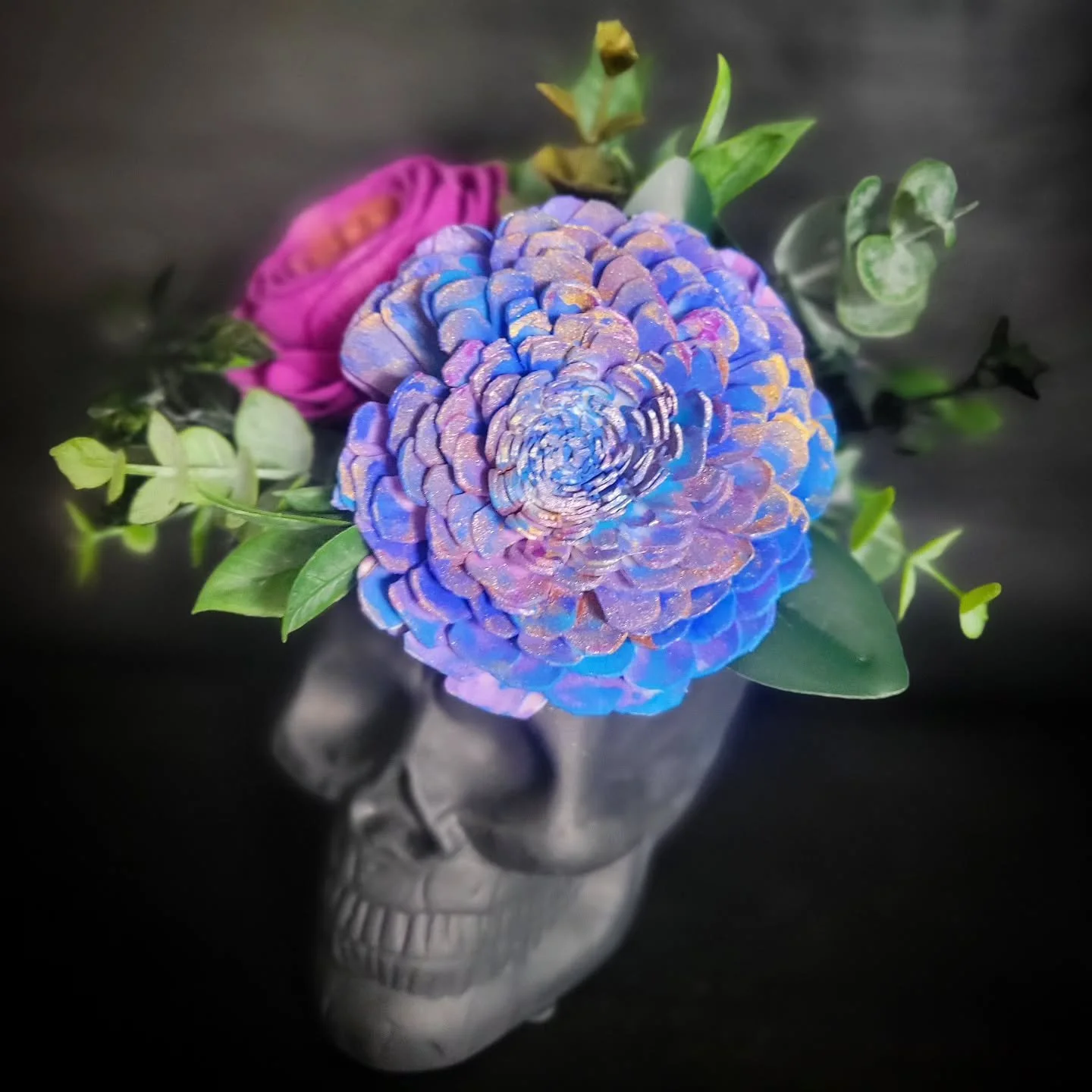 A cute little skull with one of my Cosmic flowers.

My Cosmic flowers are metallic, glittery, multi-colored flowers that have been carefully airbrushed and handpainted, meaning each one is one of a kind 🌌

#WoodFlowers #WoodFlowerFlorist #OhioFloris