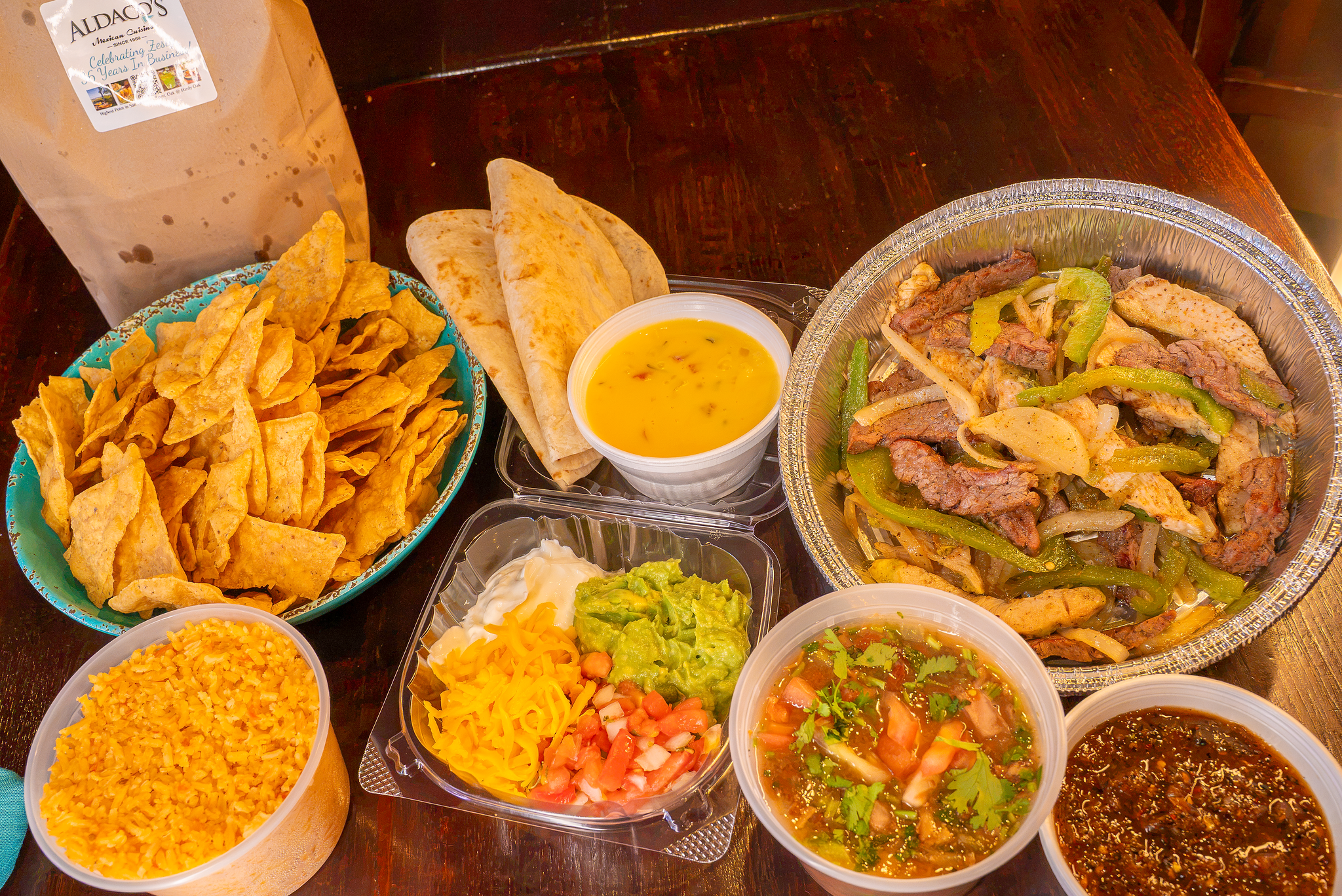 Aldaco's Fajita Family Pack to-go with chips, queso, rice, beans, guacamole and tortillas in San Antonio