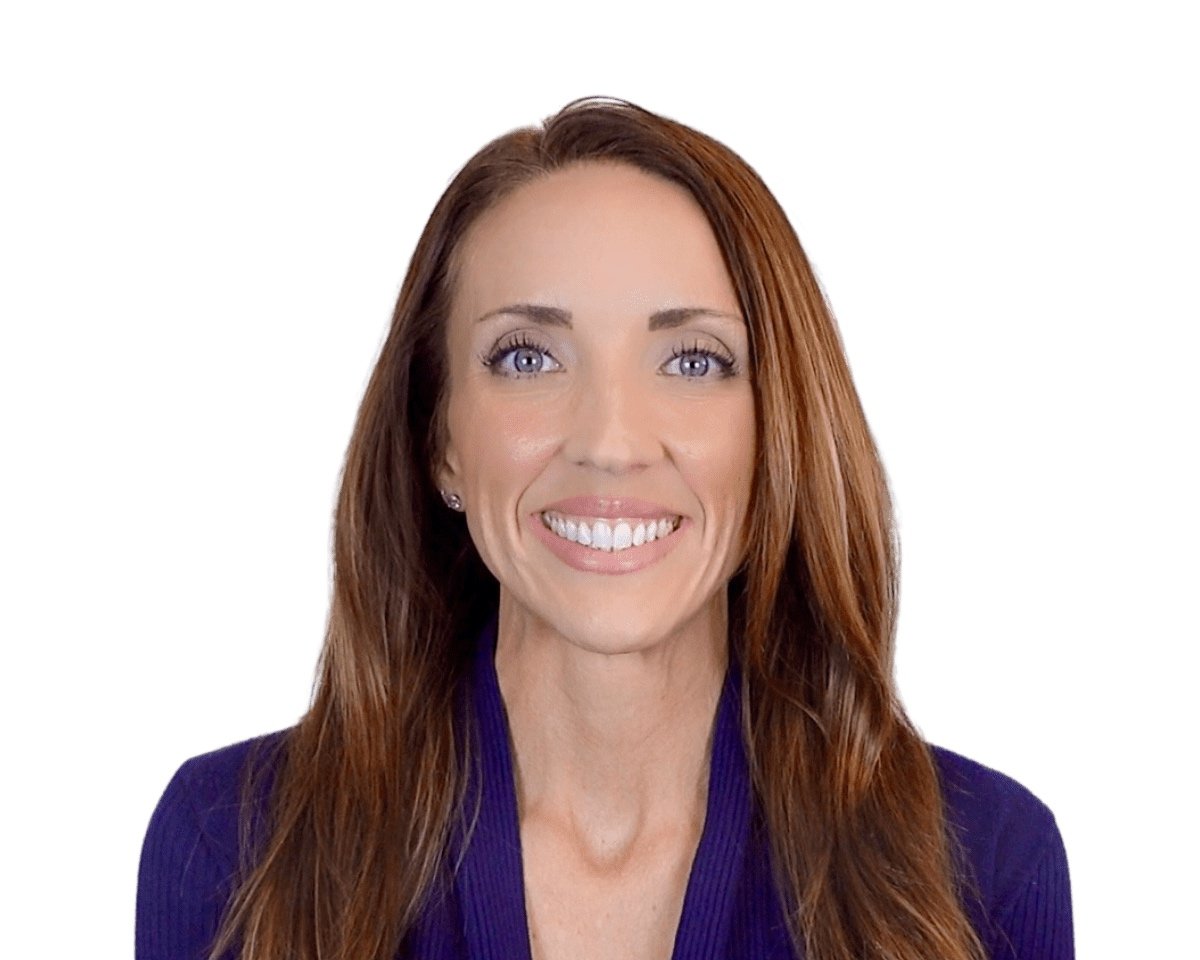 A woman with long reddish-brown hair, blue eyes, wearing a dark blazer, smiling against a white background.