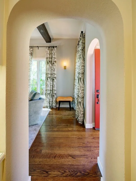 An arched doorway transforms a simple transition into a graceful vista. #architecturaldetails #classicdesign