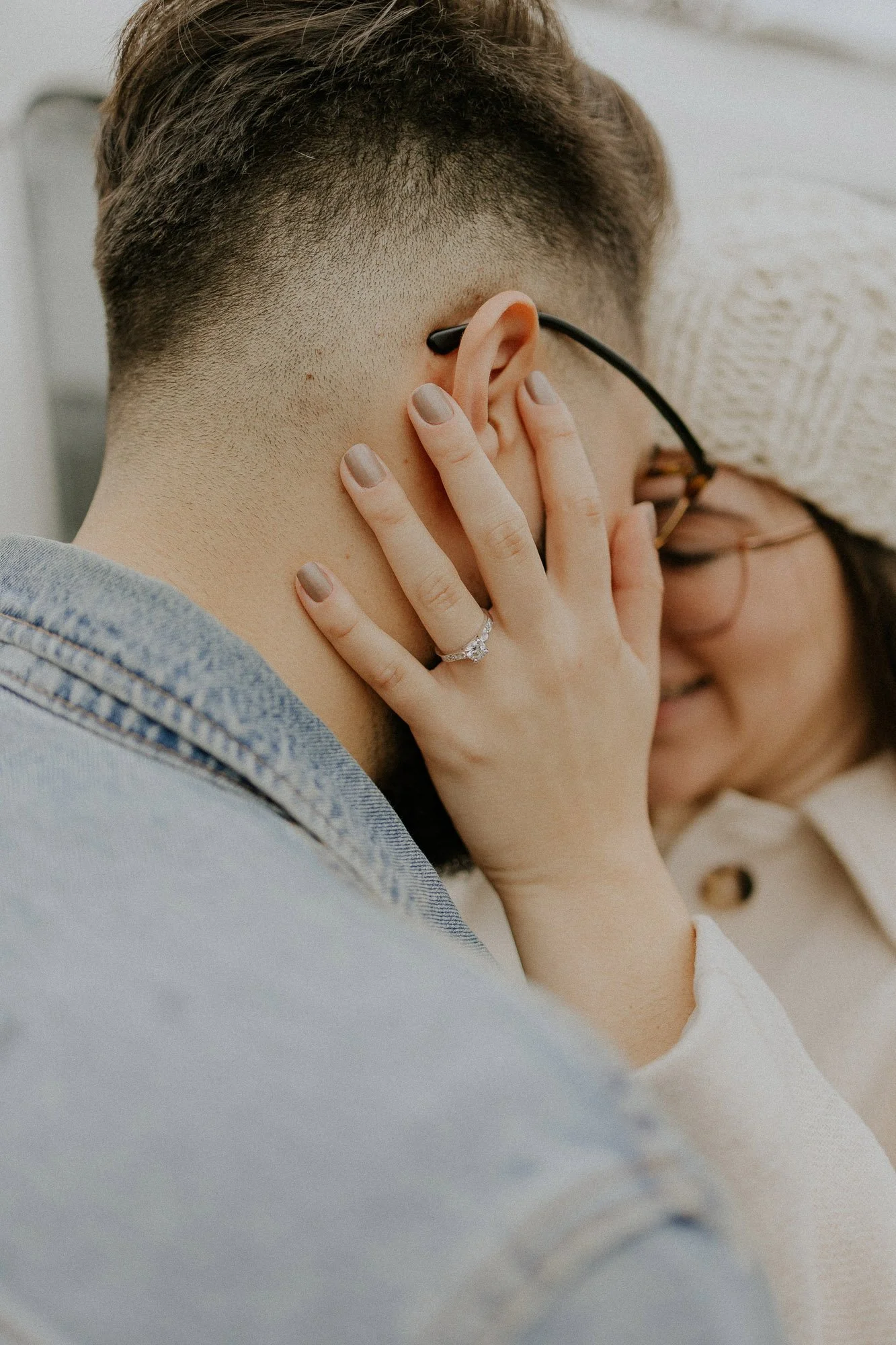 close-up-womans-hand-on-mans-cheek-engagement-ring-couples-photographer-autumn-skye.jpg