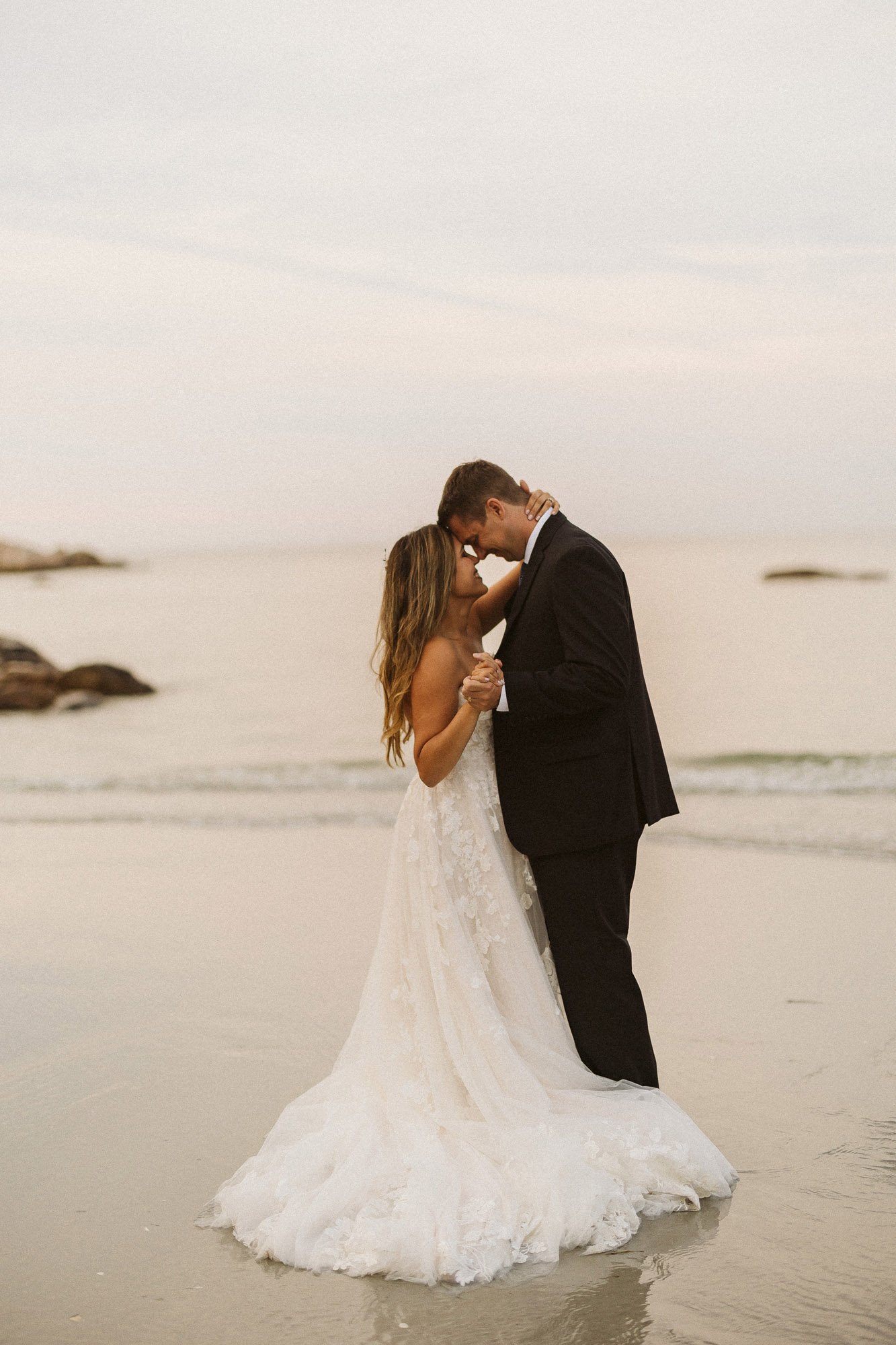 bride-groom-embracing-on-beach-couples-photographer-autumn-skye-phoenix-boston.jpg