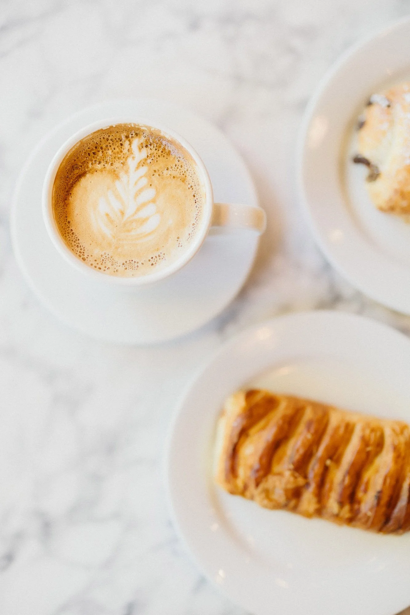 aerial-shot-coffee-pastry-white-plates-marble-counter-branding-photographer-autumn-skye.jpg