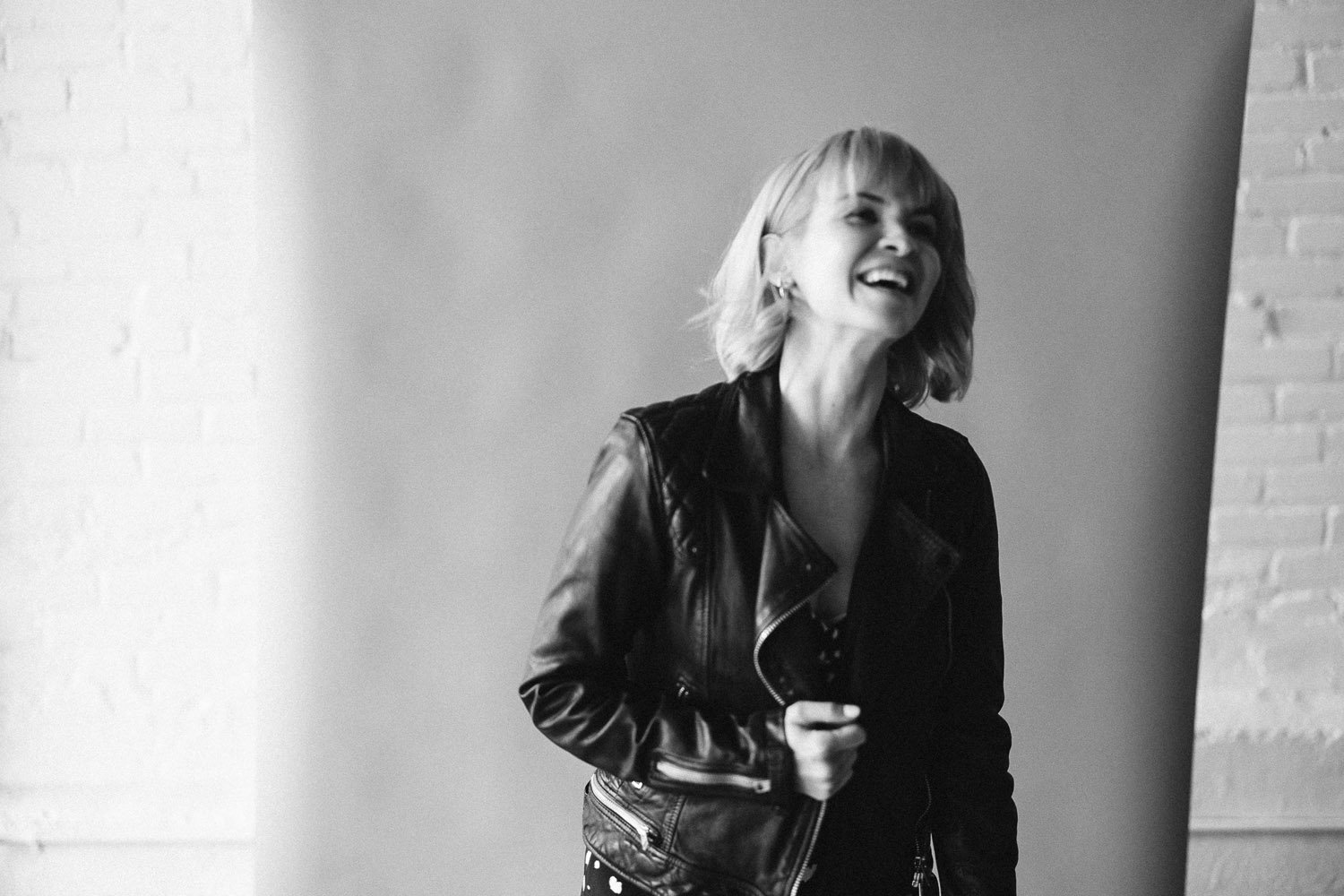 laughing-blonde-woman-leather-jacket-monochrome-branding-photographer-autumn-skye.jpg