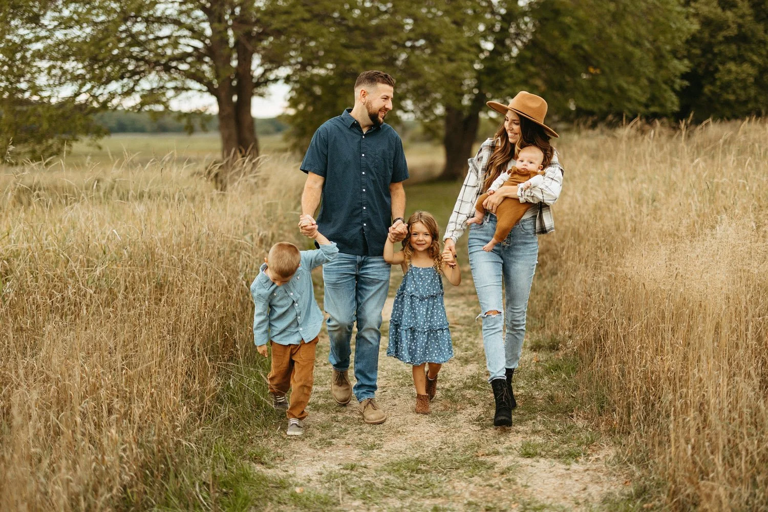mom-dad-boy-girl-and-baby-walking-through-field-fall-family-photographer.jpg