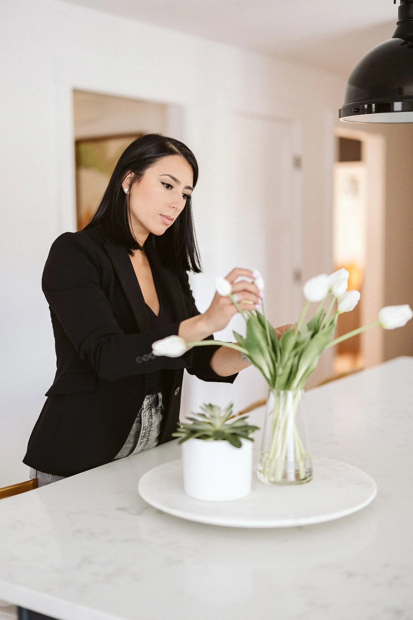 brunette-woman-arranaging-white-tulips-in-vase-branding-photographer-phoenix-boston.jpg