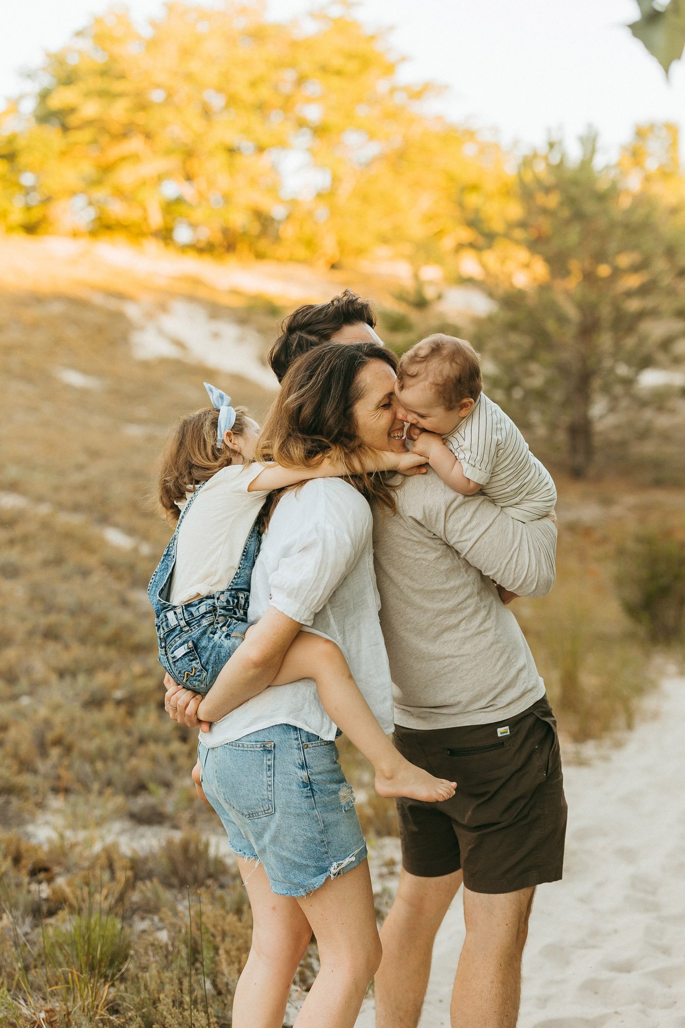 baby-kissing-momma-piggybacking-daughter-family-photographer-autumn-skye-phoenix-boston.jpg