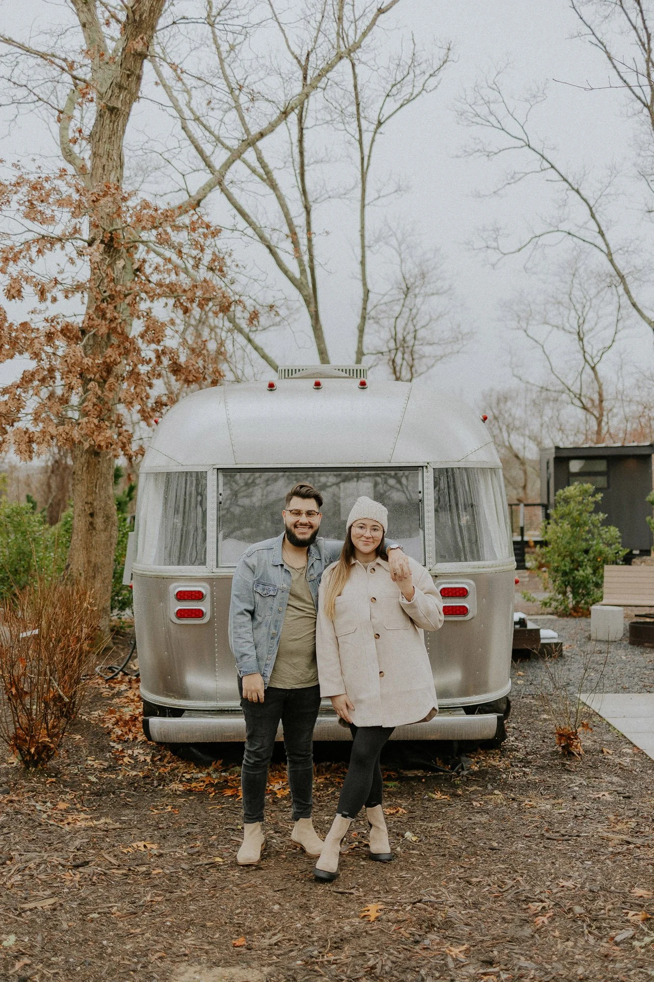 man-with-arm-around-woman-outside-airstream-fall-couples-photography-autumn-skye-phoenix-boston.jpg