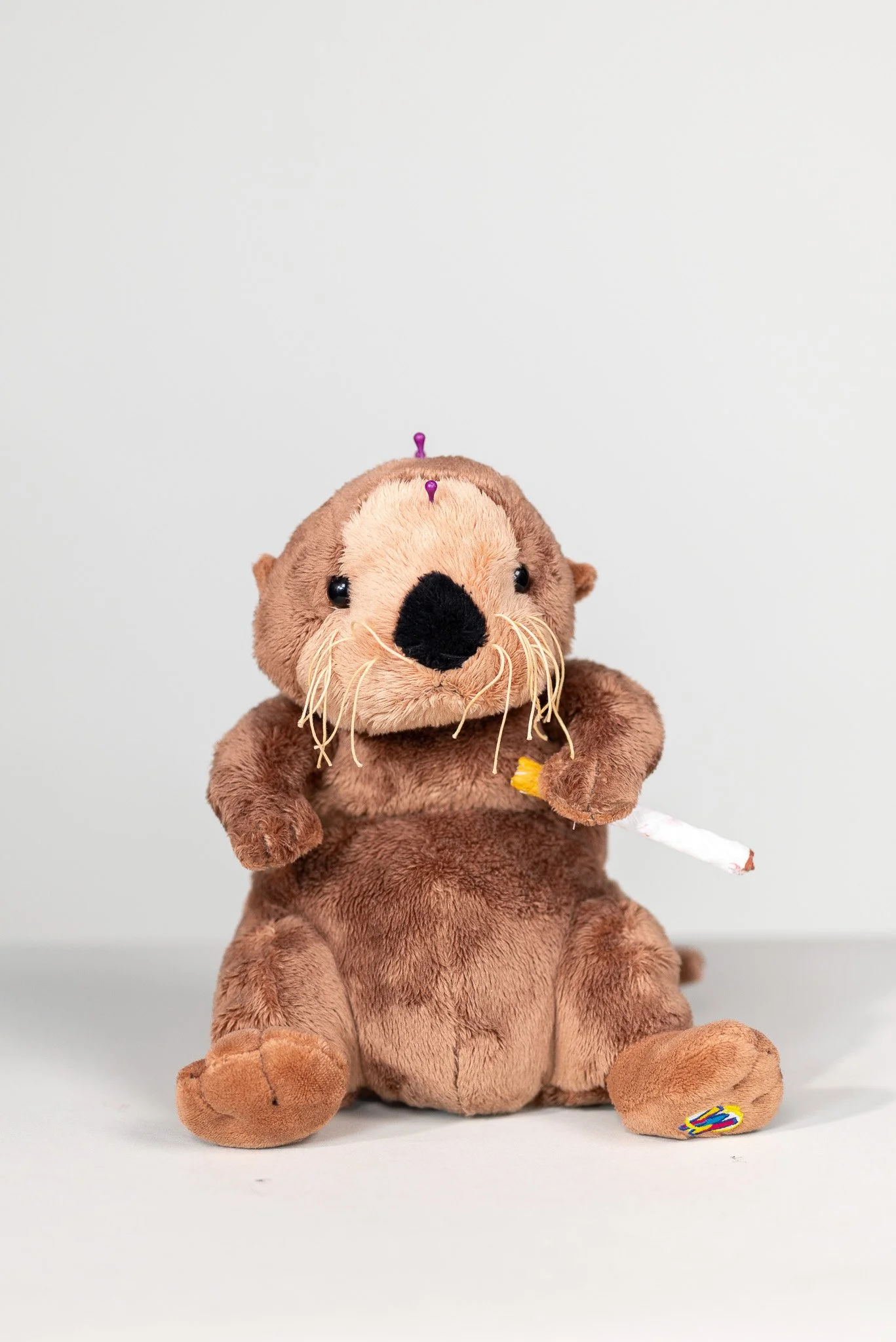 found otter plush with pins and a rope cigarette from Jeff Beaver