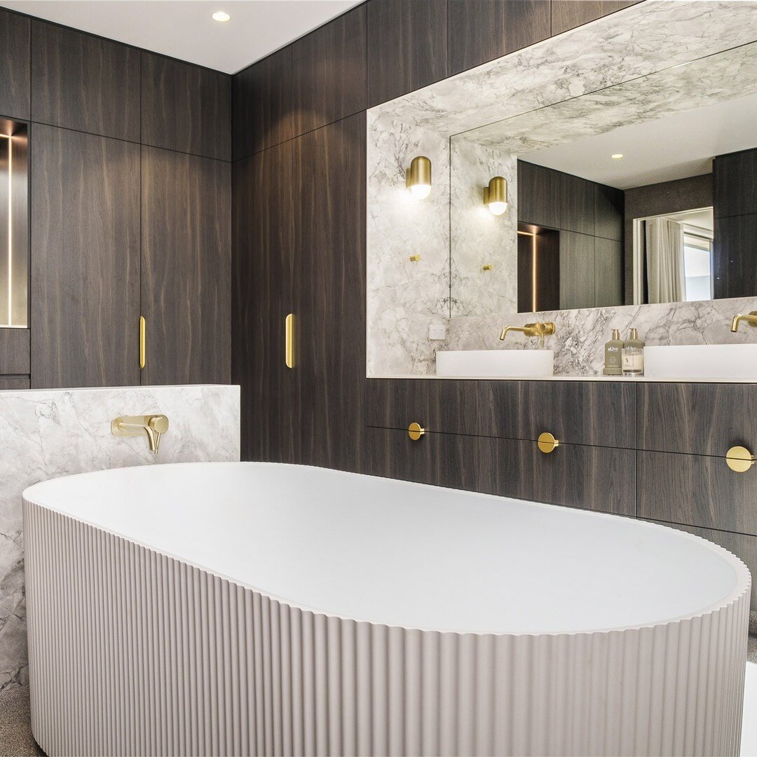 Transforming my clients' dreams into realities: A luxurious combined bathroom &amp; walk-in-robe oasis. The bathtub central with the stunning dark cupboards and lux vanity, shower and toilet tucked behind a large feature arch. Natural light flowing f