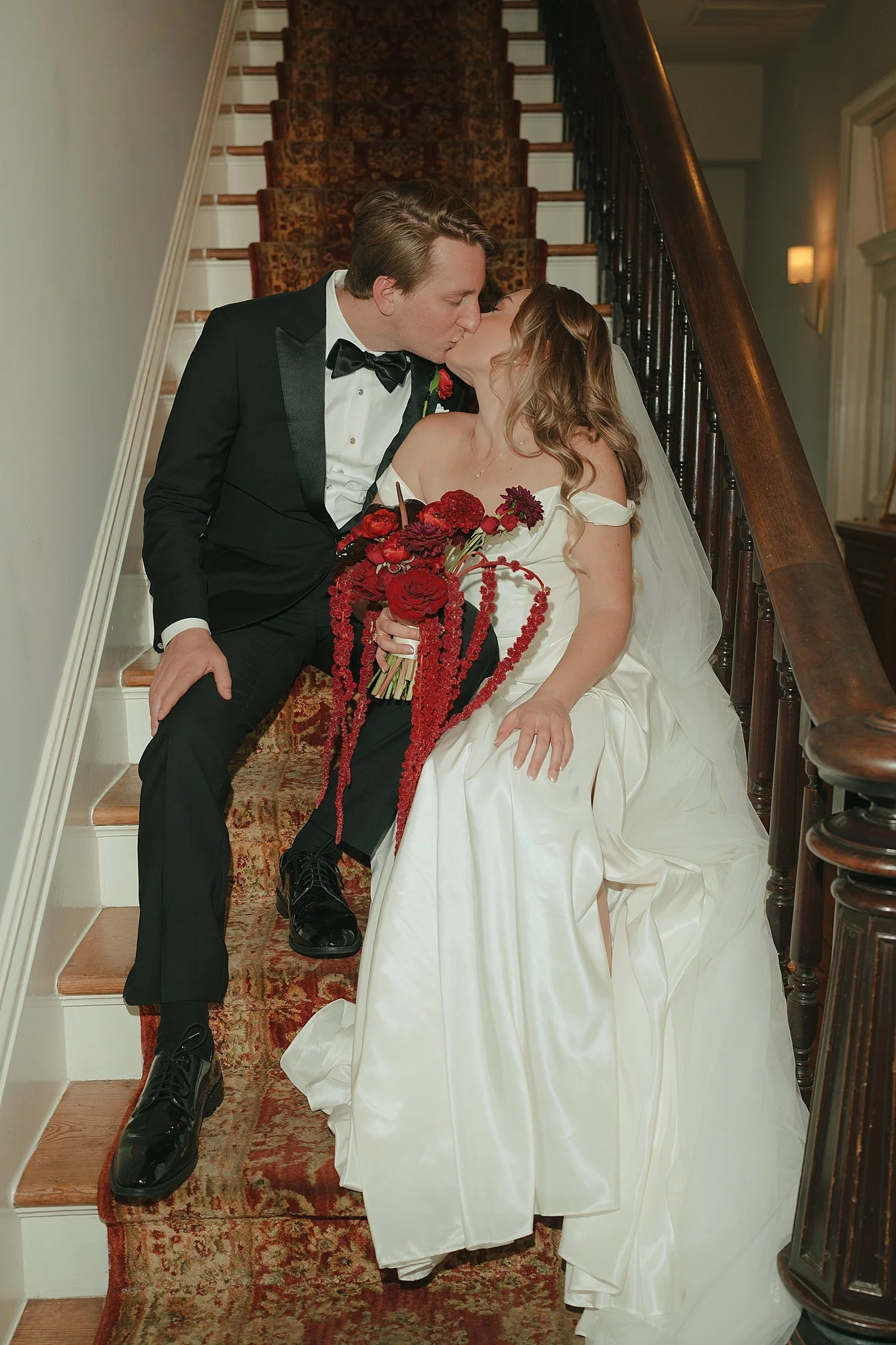  couple sits together on the stairs in their formal attire by Austin wedding photographer 