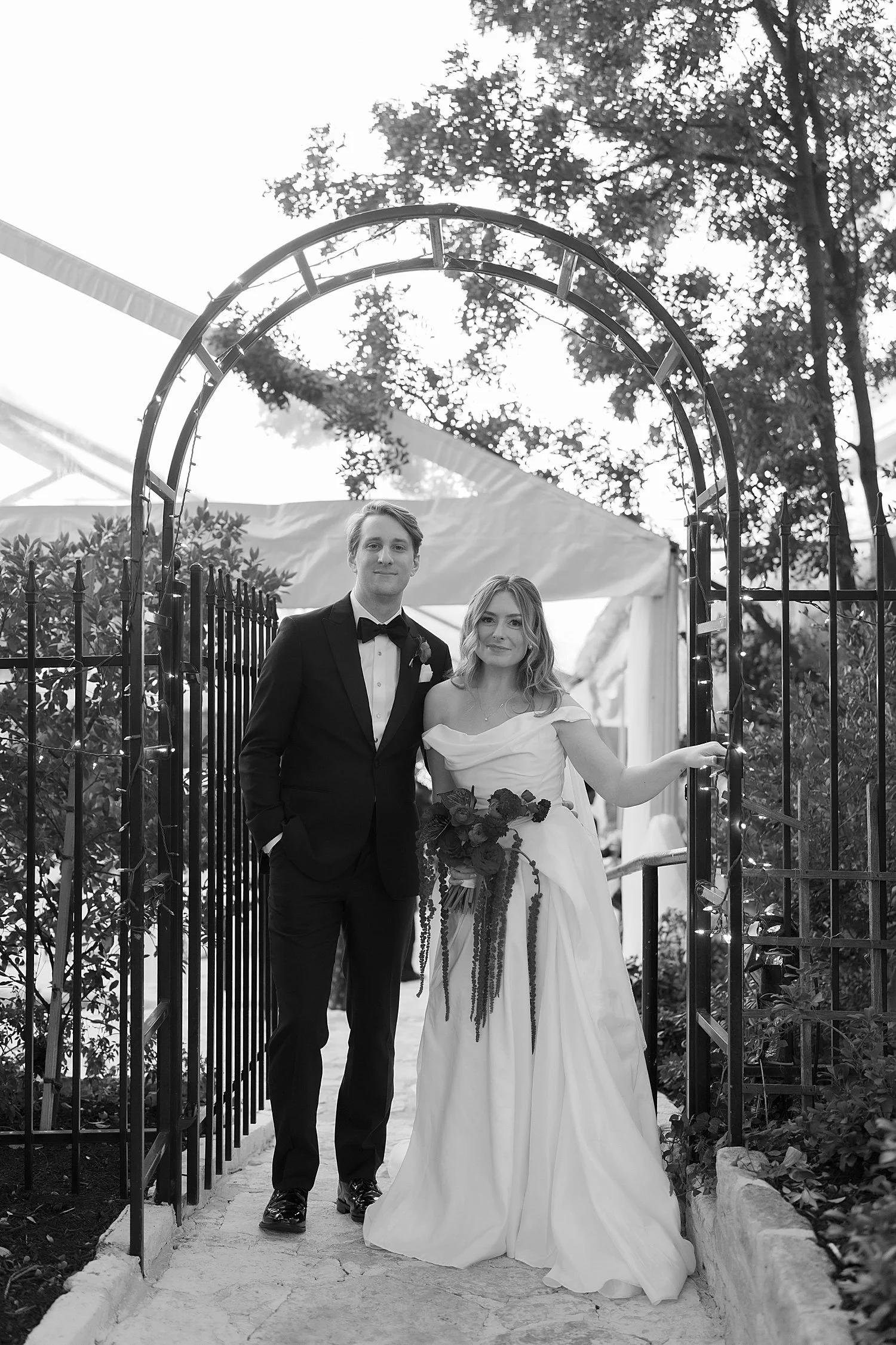  newlyweds walk through an archway in garden by Jessica Joseph Photography 