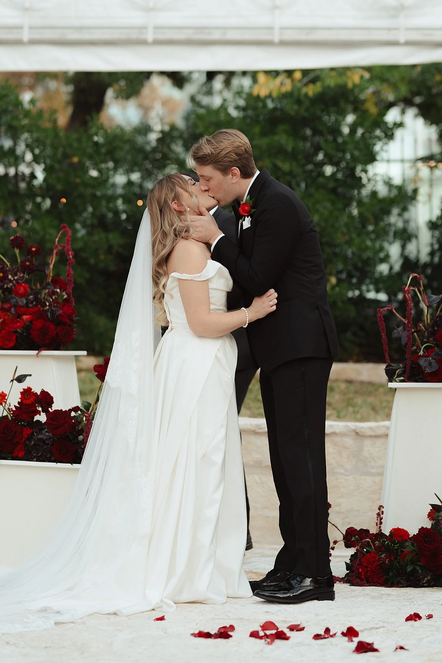  new husband and wife share a kiss at the alter by Jessica Joseph Photography 