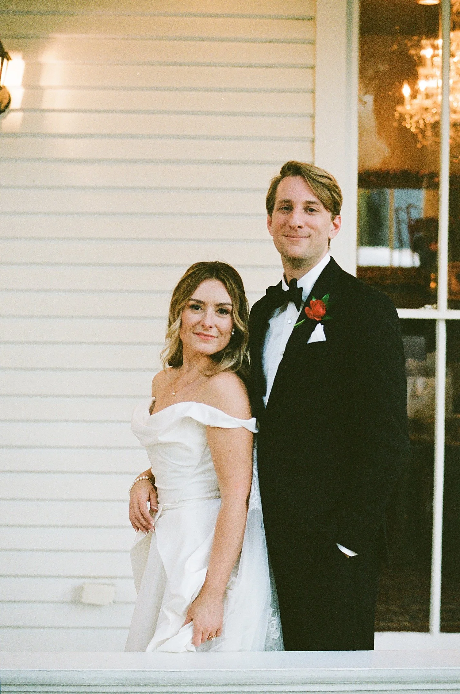  newlyweds stand on the porch at The Allan House 
