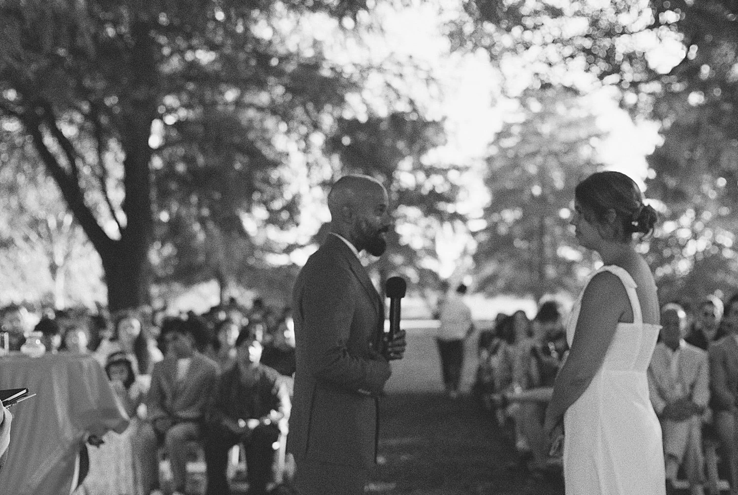  man and woman exchange vows under tree by Austin wedding photographer 