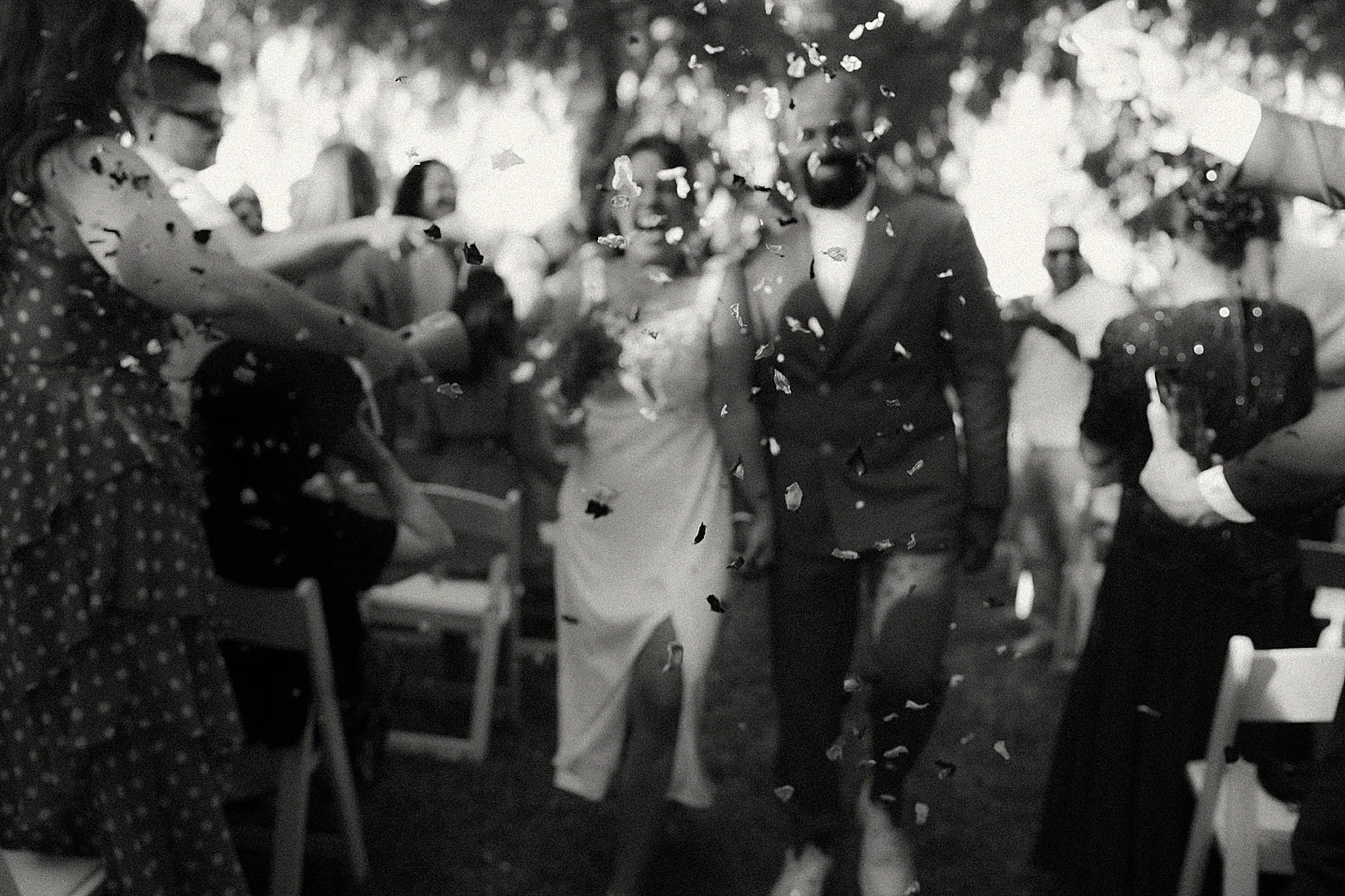  bride and groom exit their ceremony while laughing by Austin wedding photographer 
