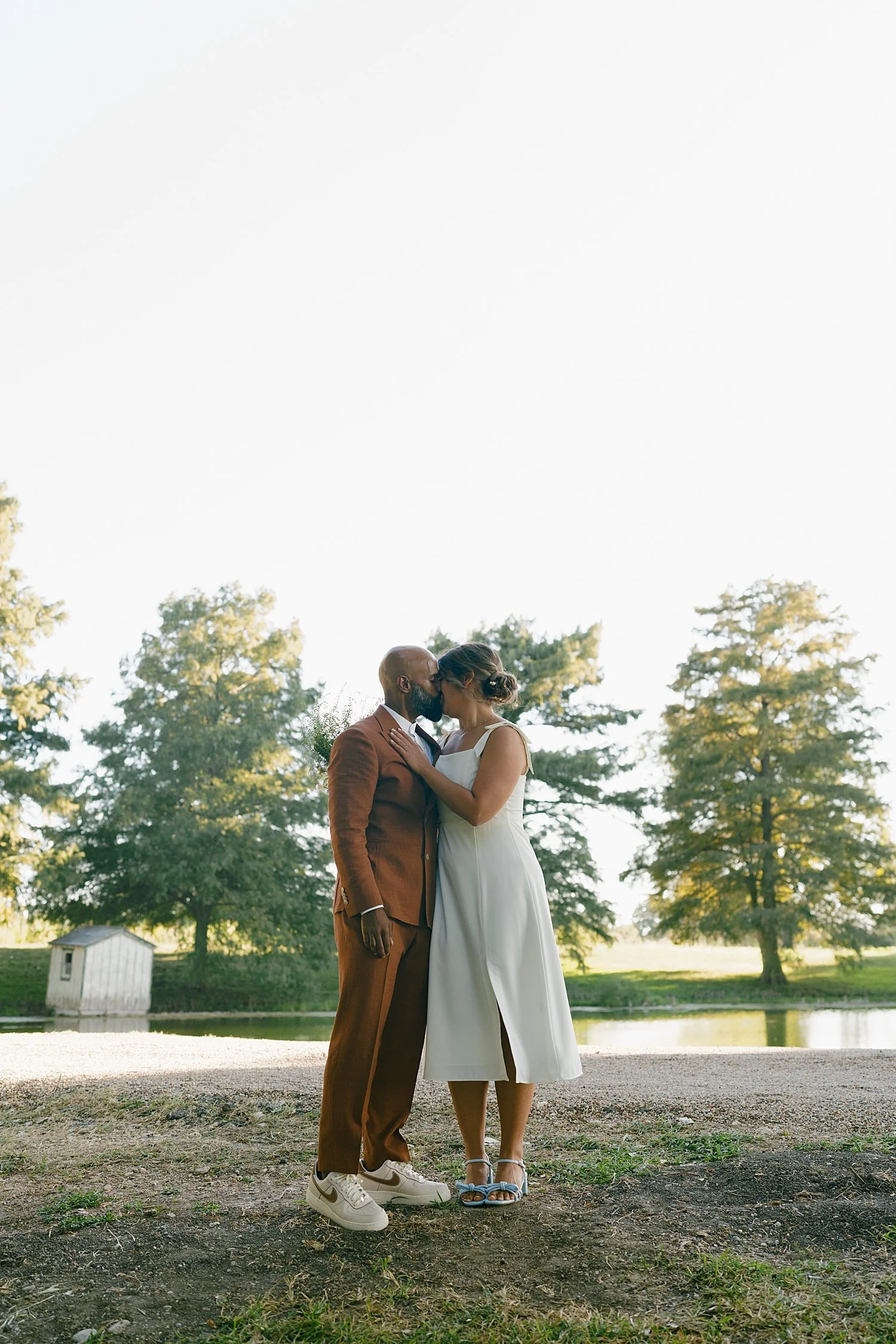  man embraces his new wife on the lawn at Springs Lake Ranch 