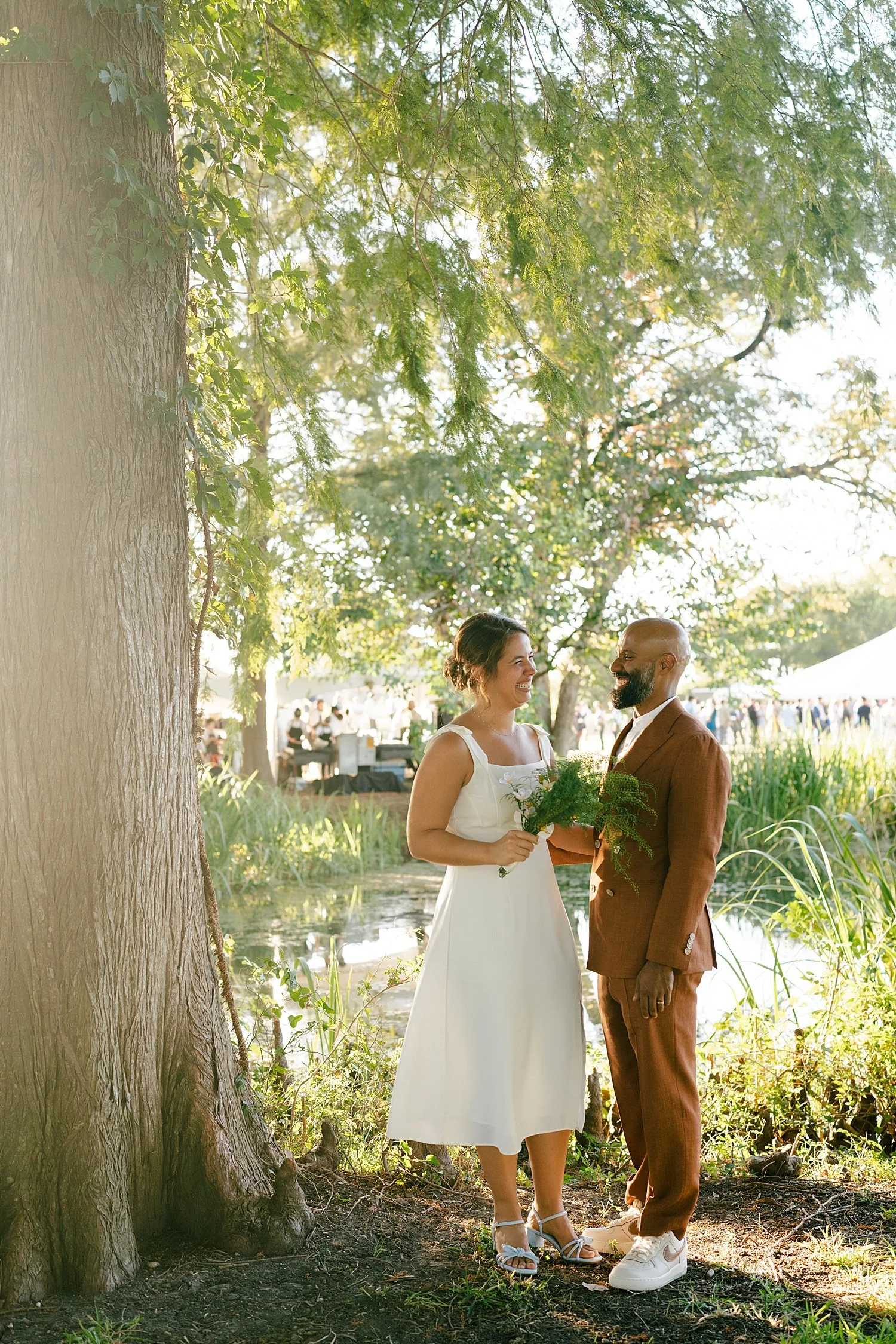  man stands next to his new wife under big tree by Jessica Joseph Photography 