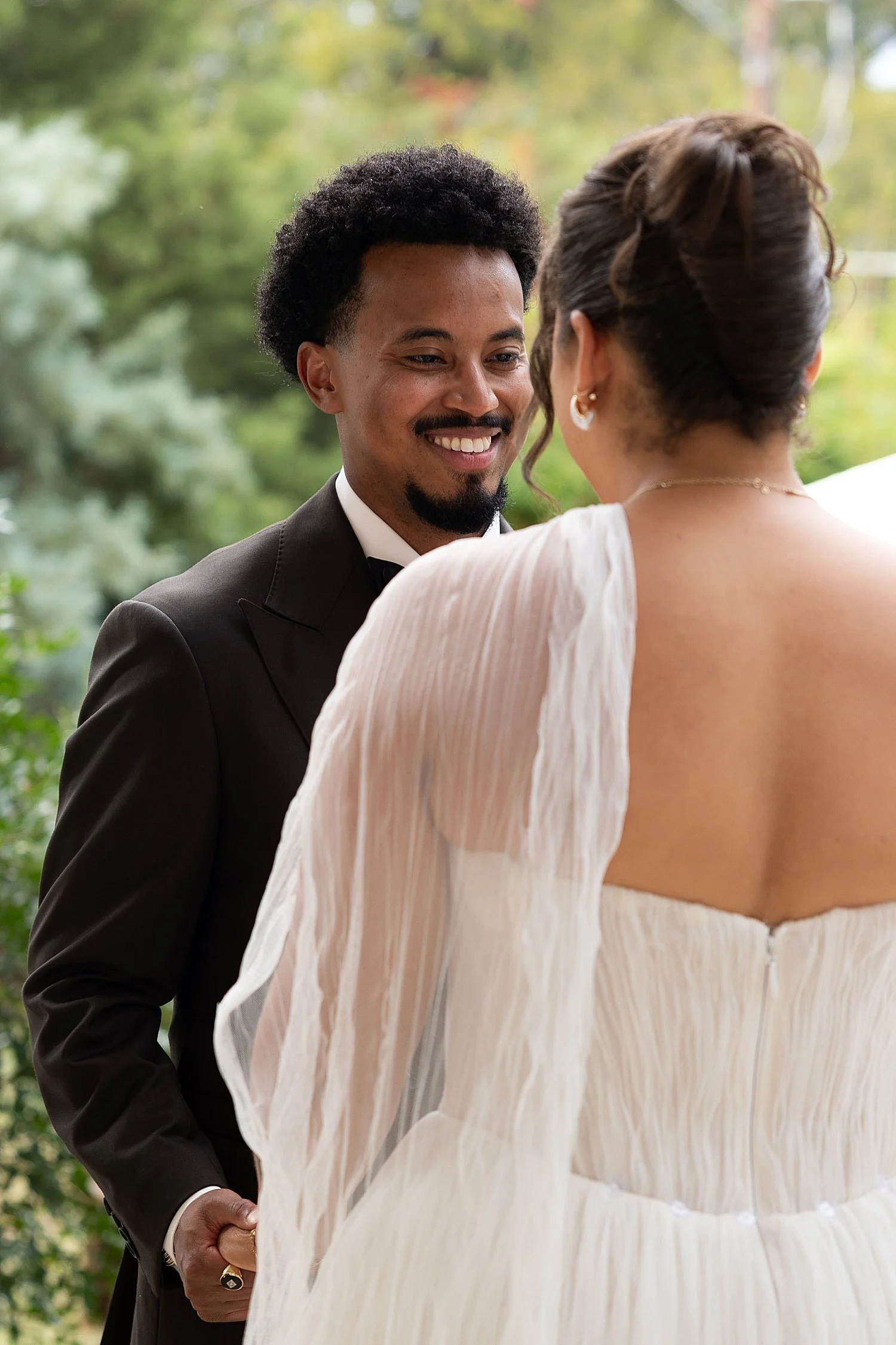  man looks lovingly at his bride during first look at The Caroline  