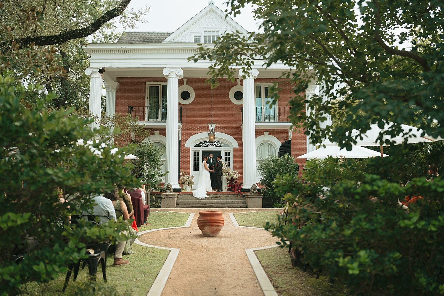  guests sit on lawn for ceremony at grand estate in Lockhart by Jessica Joseph Photography 