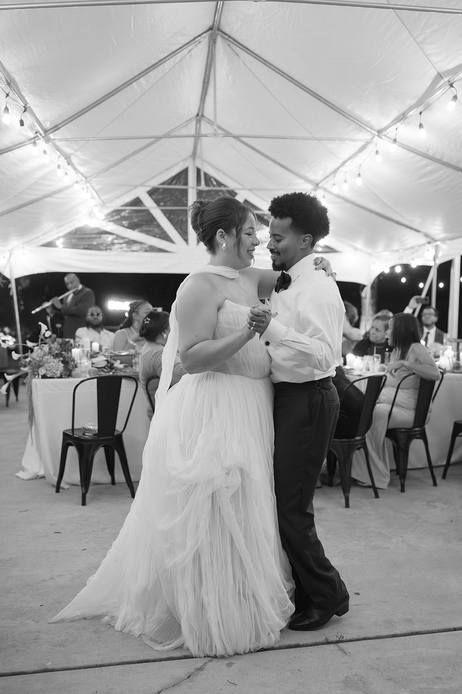  newlyweds share a first dance under tented reception space by Jessica Joseph Photography 