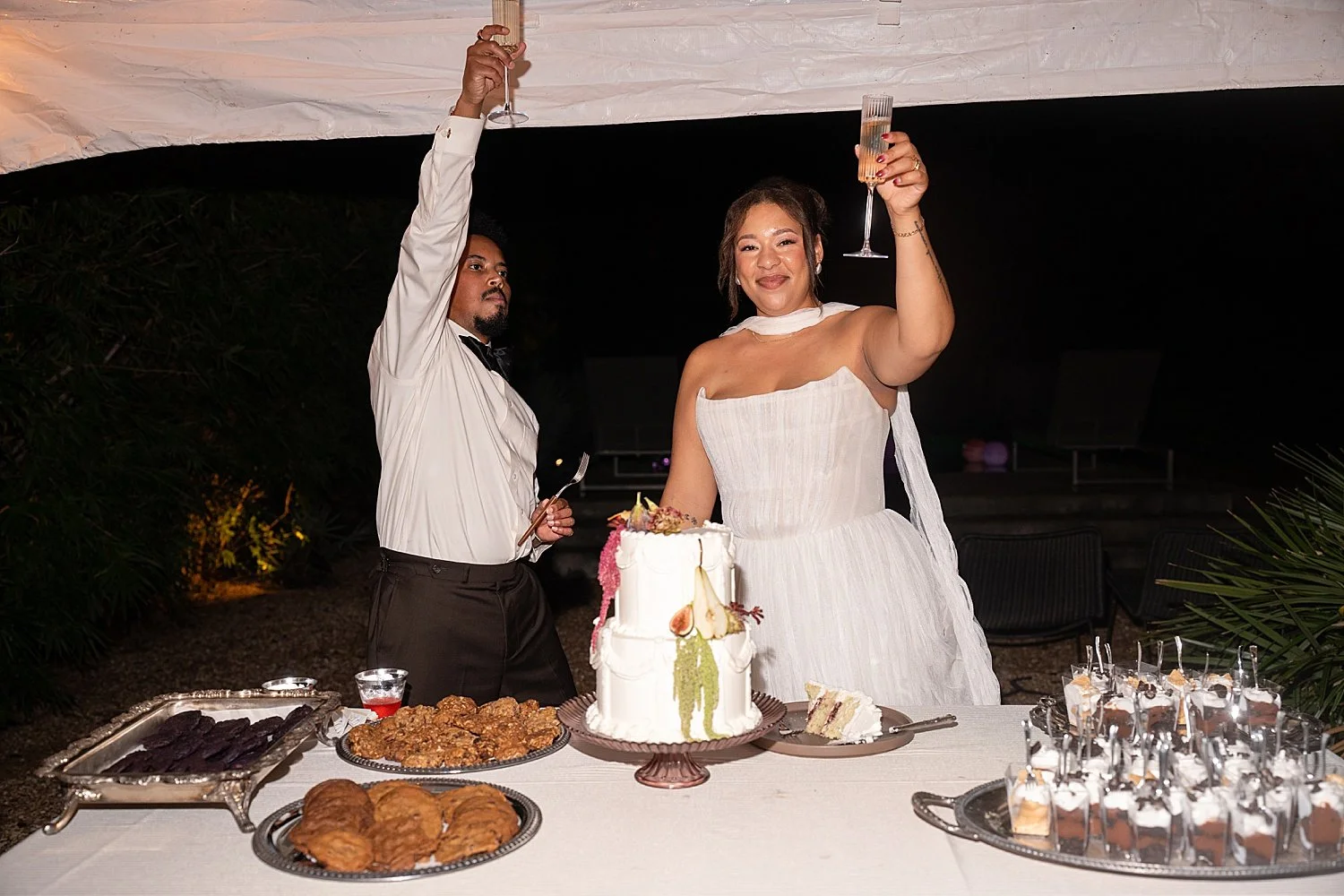  newlyweds raise a toast during their reception by Austin wedding photographer 