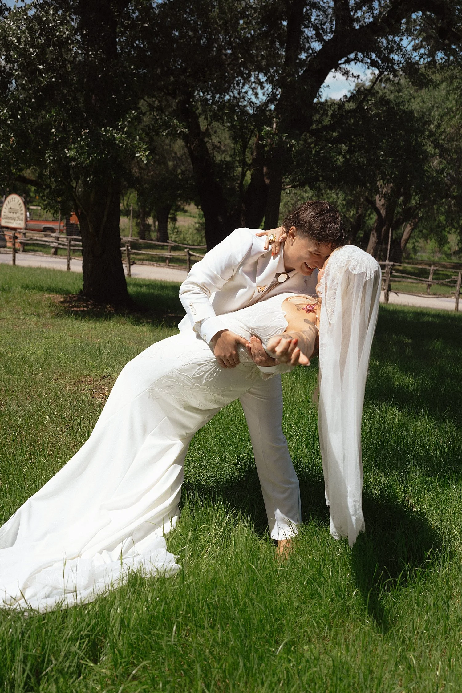  bride dips her new wife for a kiss by Austin wedding photographer 