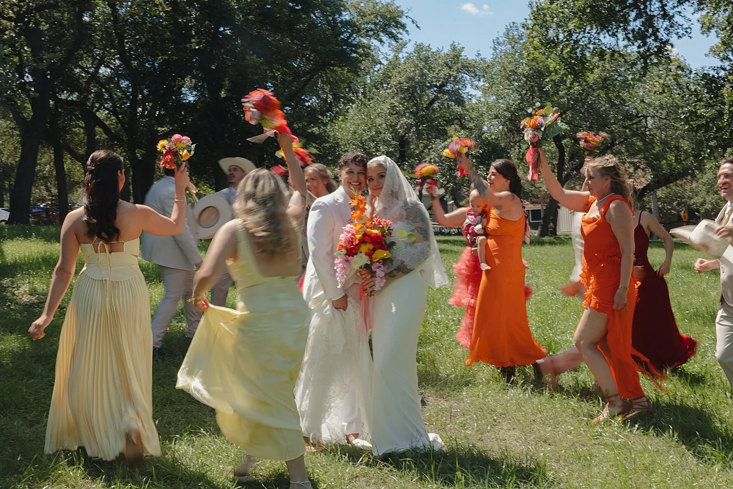  girls in bright dresses walk around newlyweds by Jessica Joseph Photography 