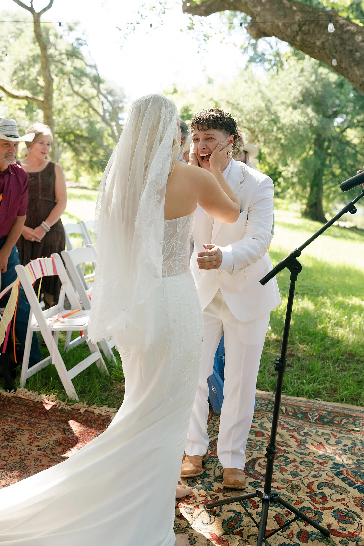 brides exchange their vows at floral alter by Austin wedding photographer 