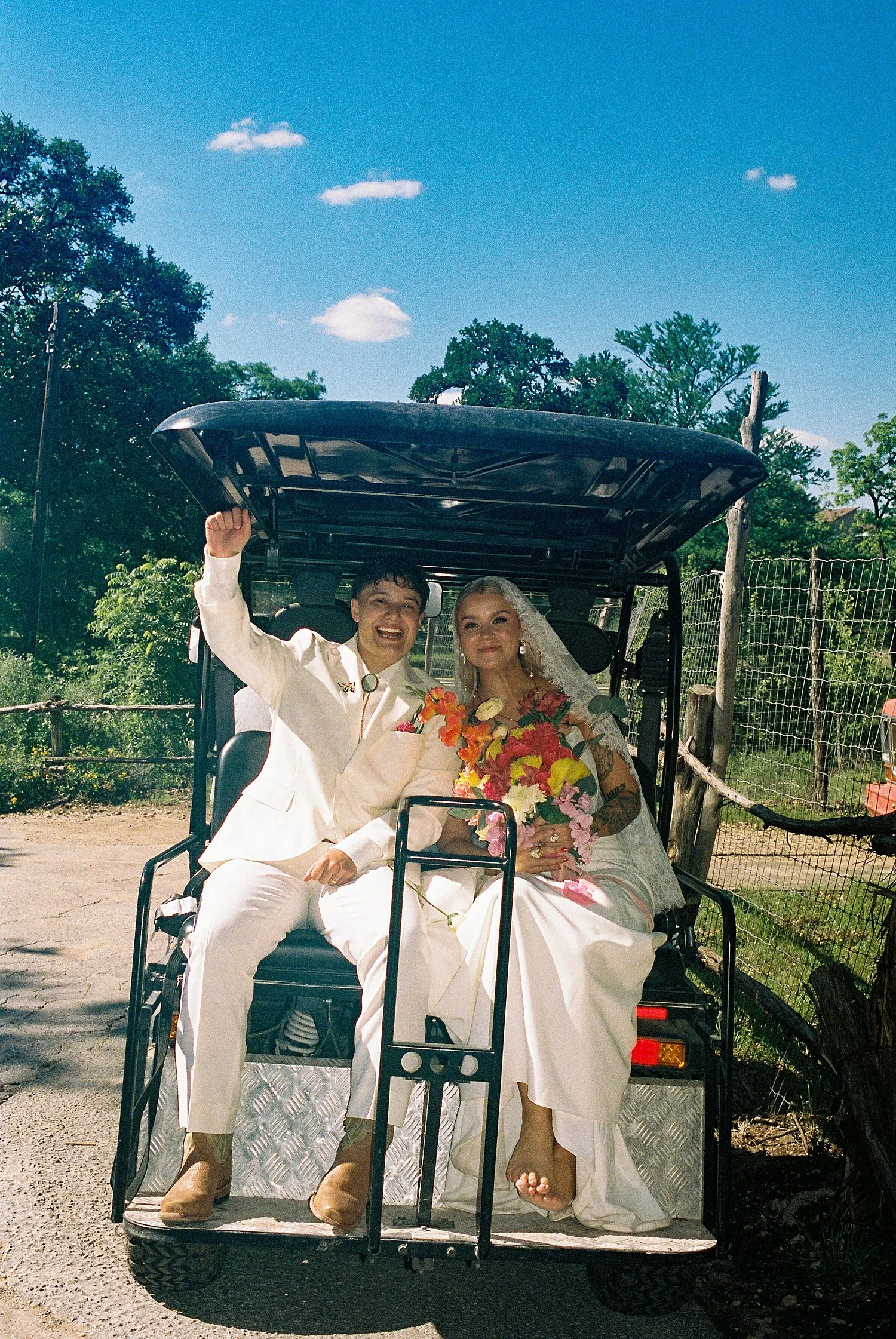  newlywed wives on the back of a golf cart by Austin wedding photographer 