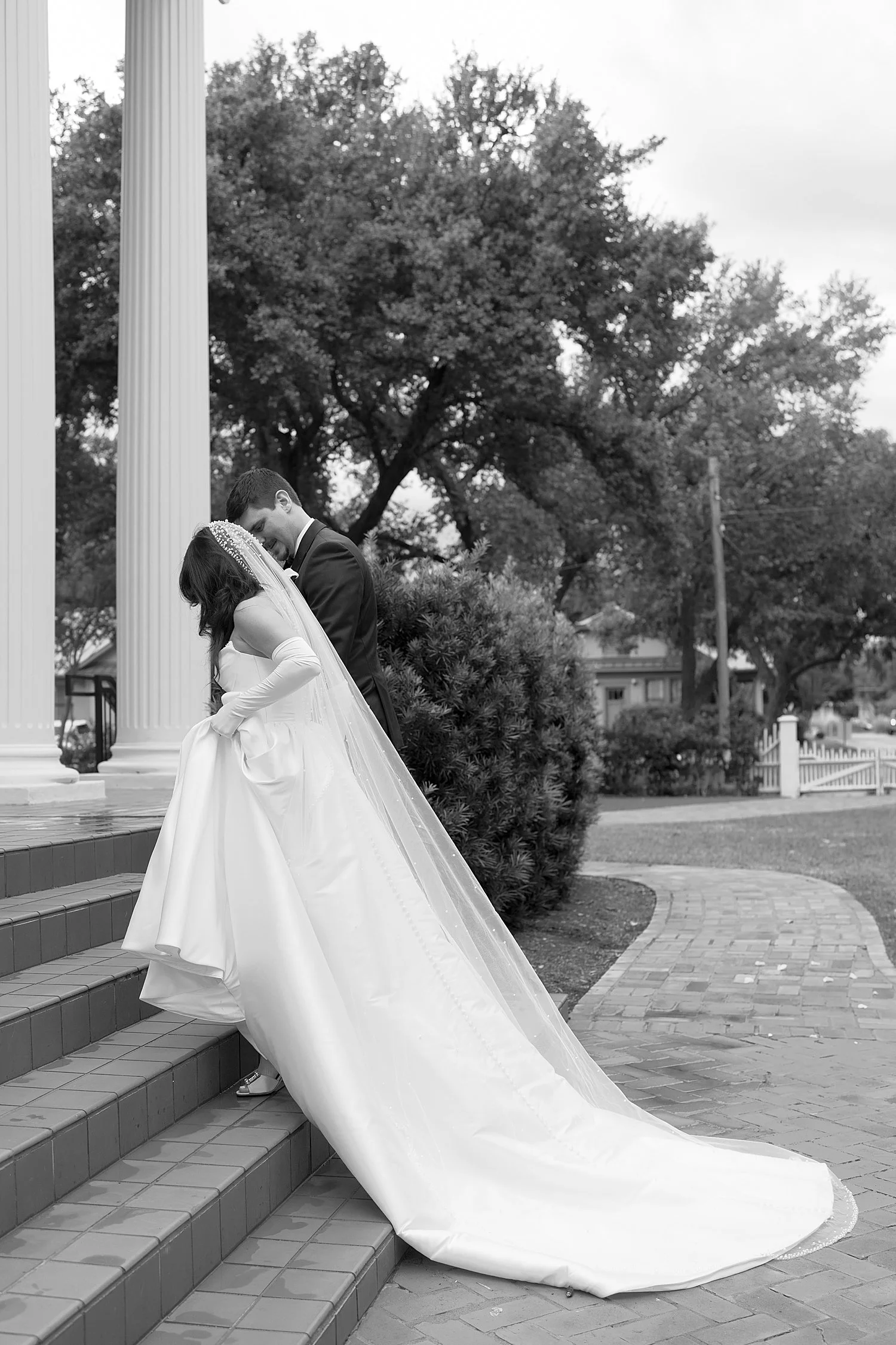  man and woman approach alter on stairs outside by Austin Wedding Photographer 