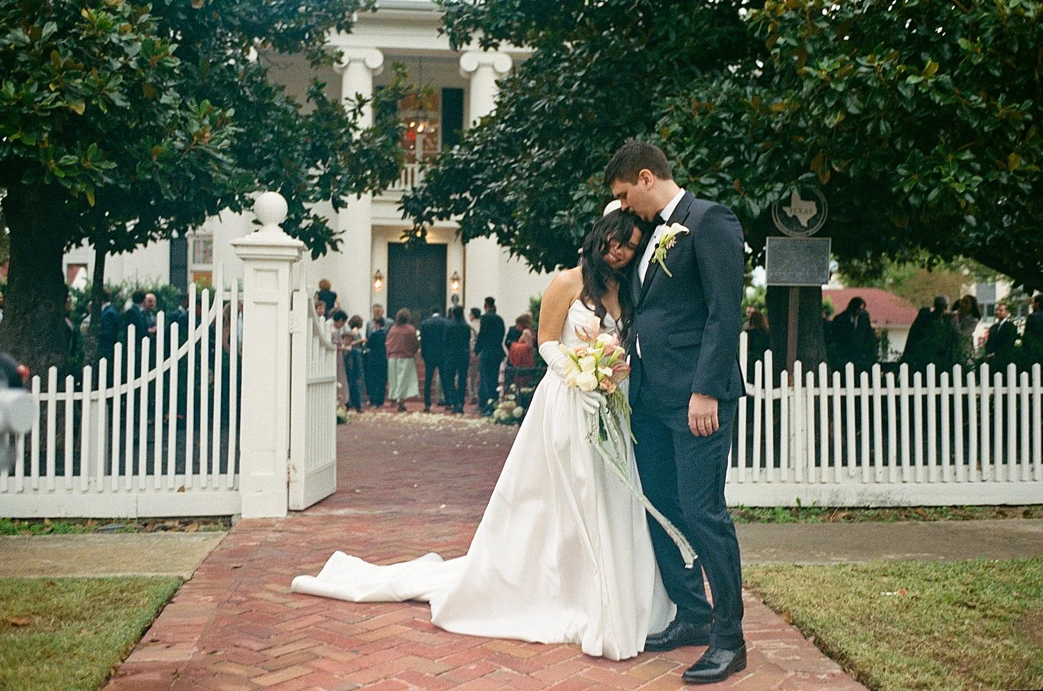  man and woman snuggle on sidewalk in Round Rock by Austin Wedding Photographer 