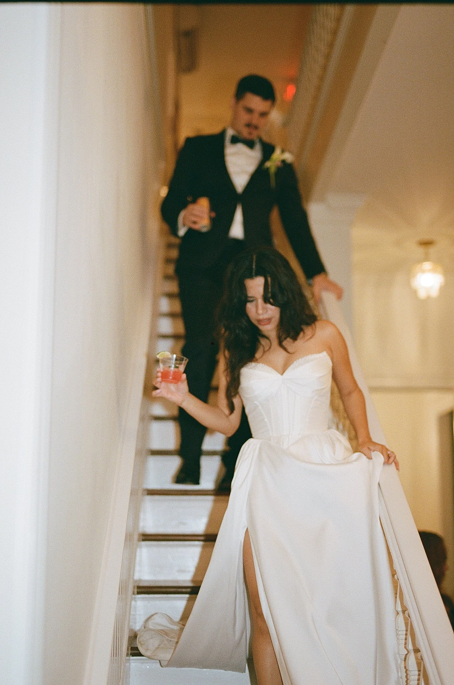  newlyweds walk down staircase at Woodbine Mansion 