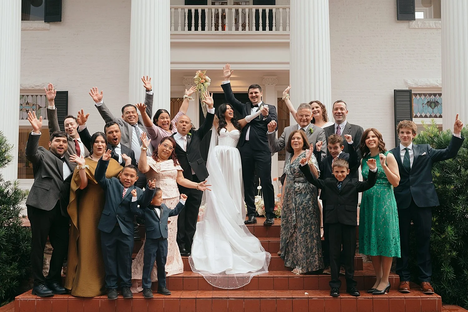  guests gather around newlyweds on steps by Jessica Joseph Photography 