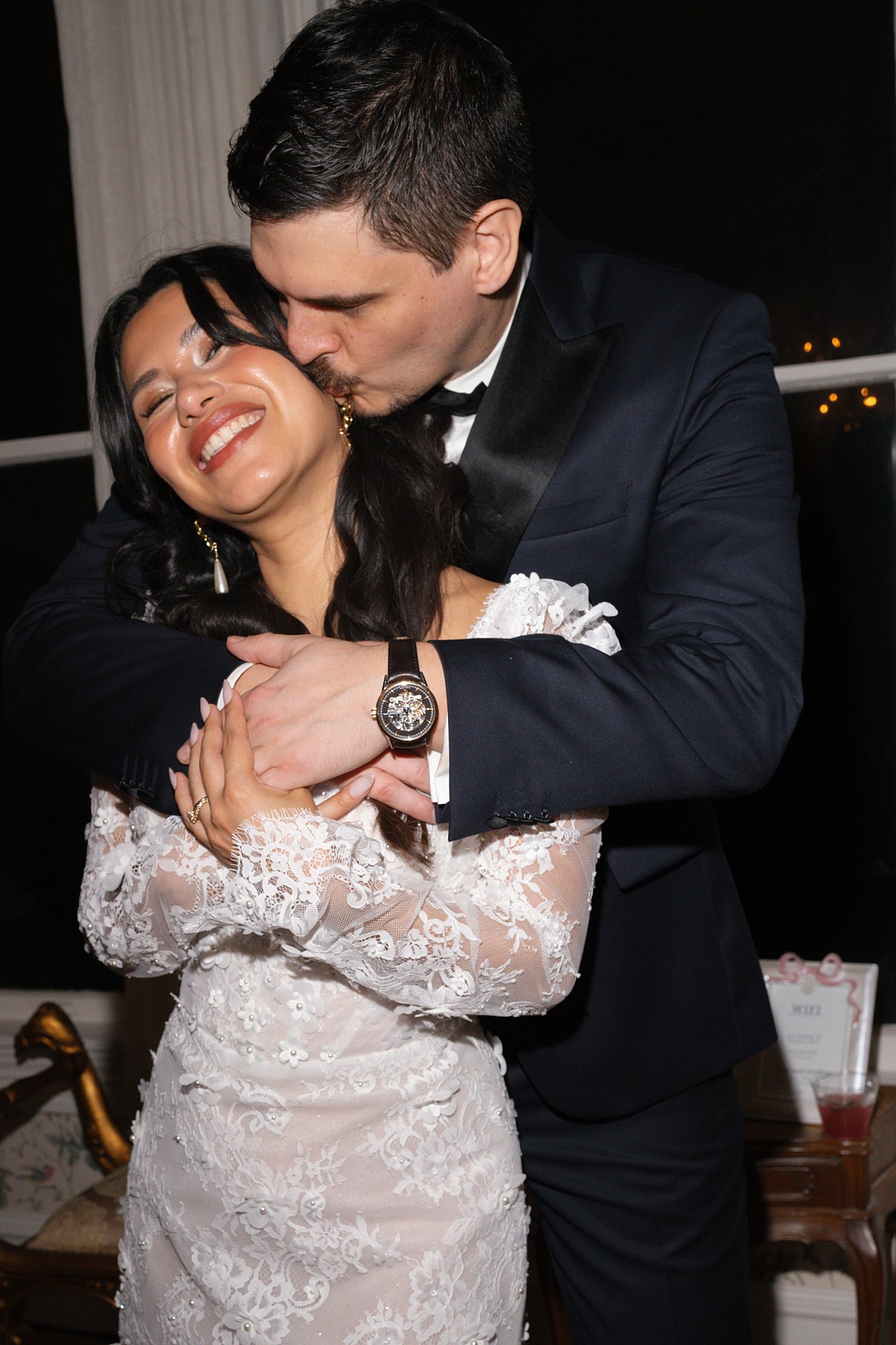  man wraps up his new wife and kisses her cheek by Jessica Joseph Photography 