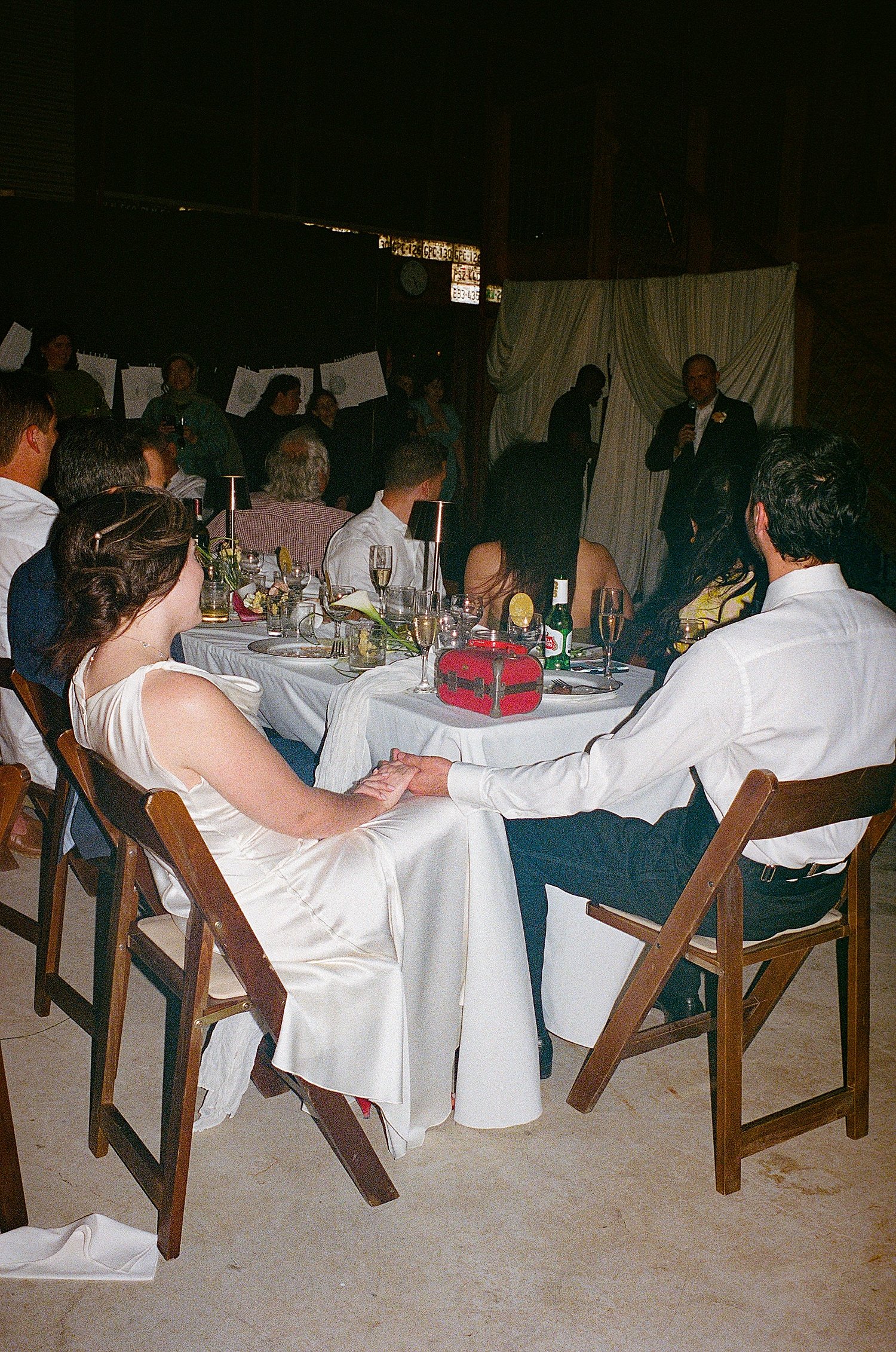  couple holds hand across corner of table by Jessica Joseph Photography 