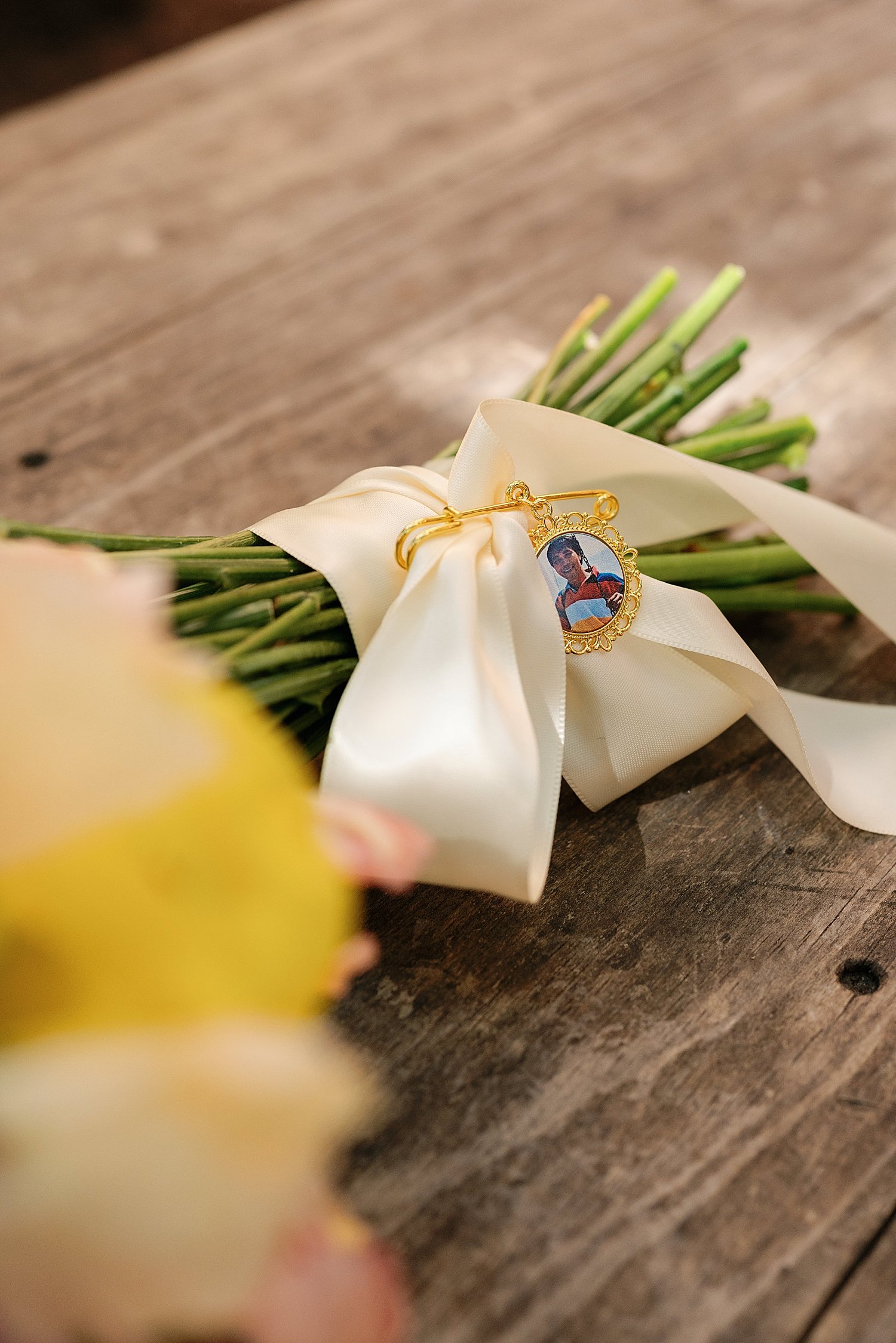  bouquet on wooden table with memorial frame for a quintessential Austin elopement 