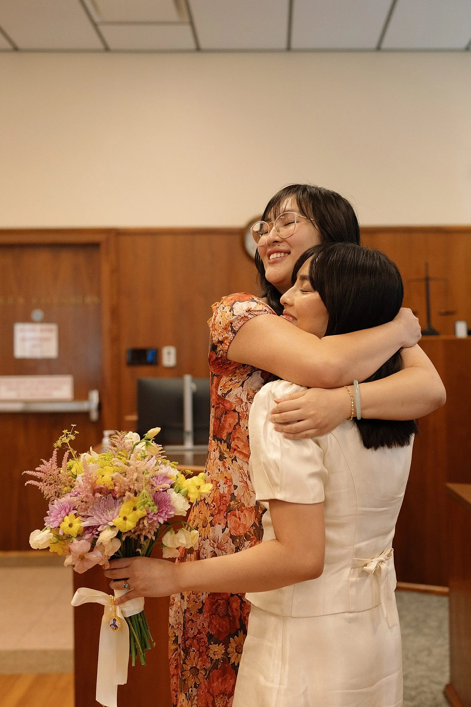  sister embraces the newly married bride with joy by Jessica Joseph Photography 