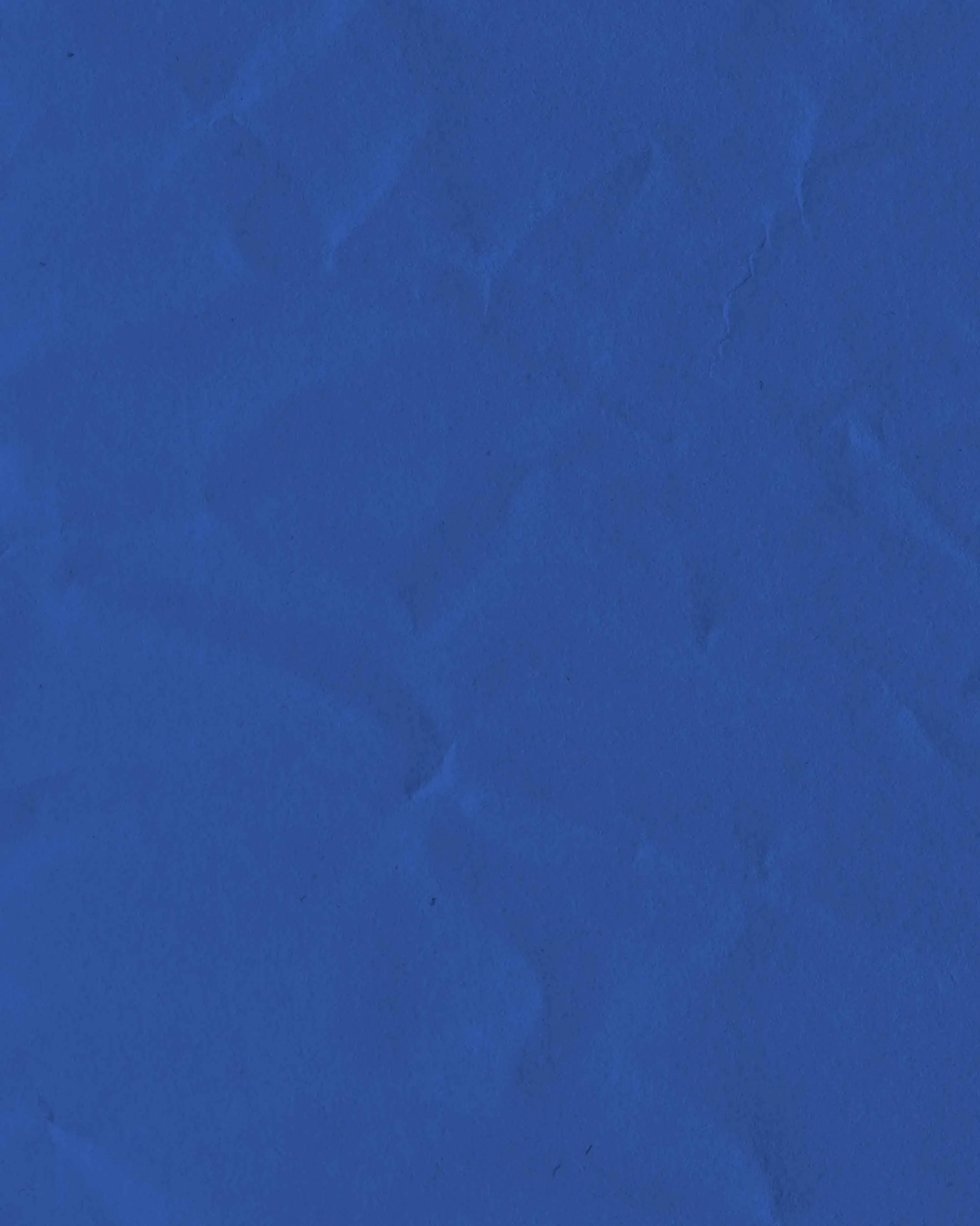 Close-up of a cracked blue surface or paper.