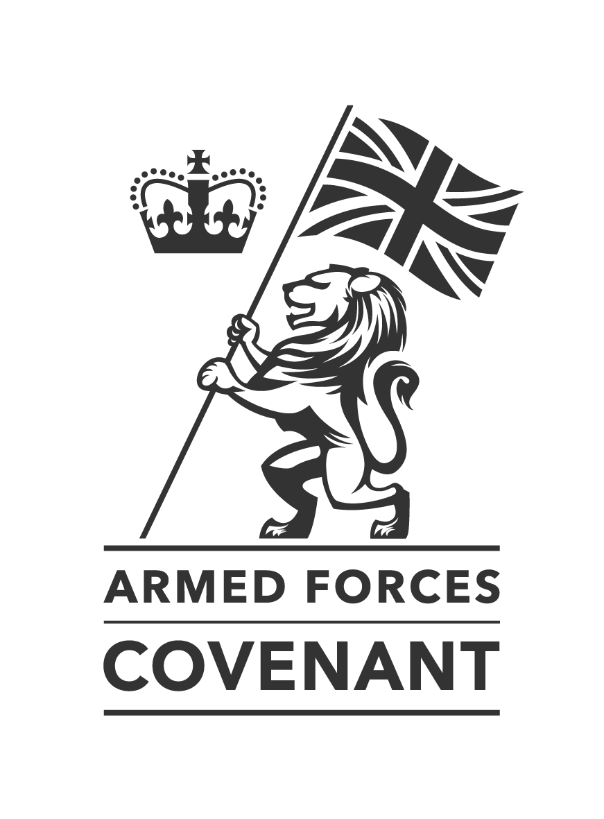 Logo of Armed Forces Covenant featuring a lion holding a Union Jack flag, with a crown symbol above, and the words 'ARMED FORCES COVENANT' below.