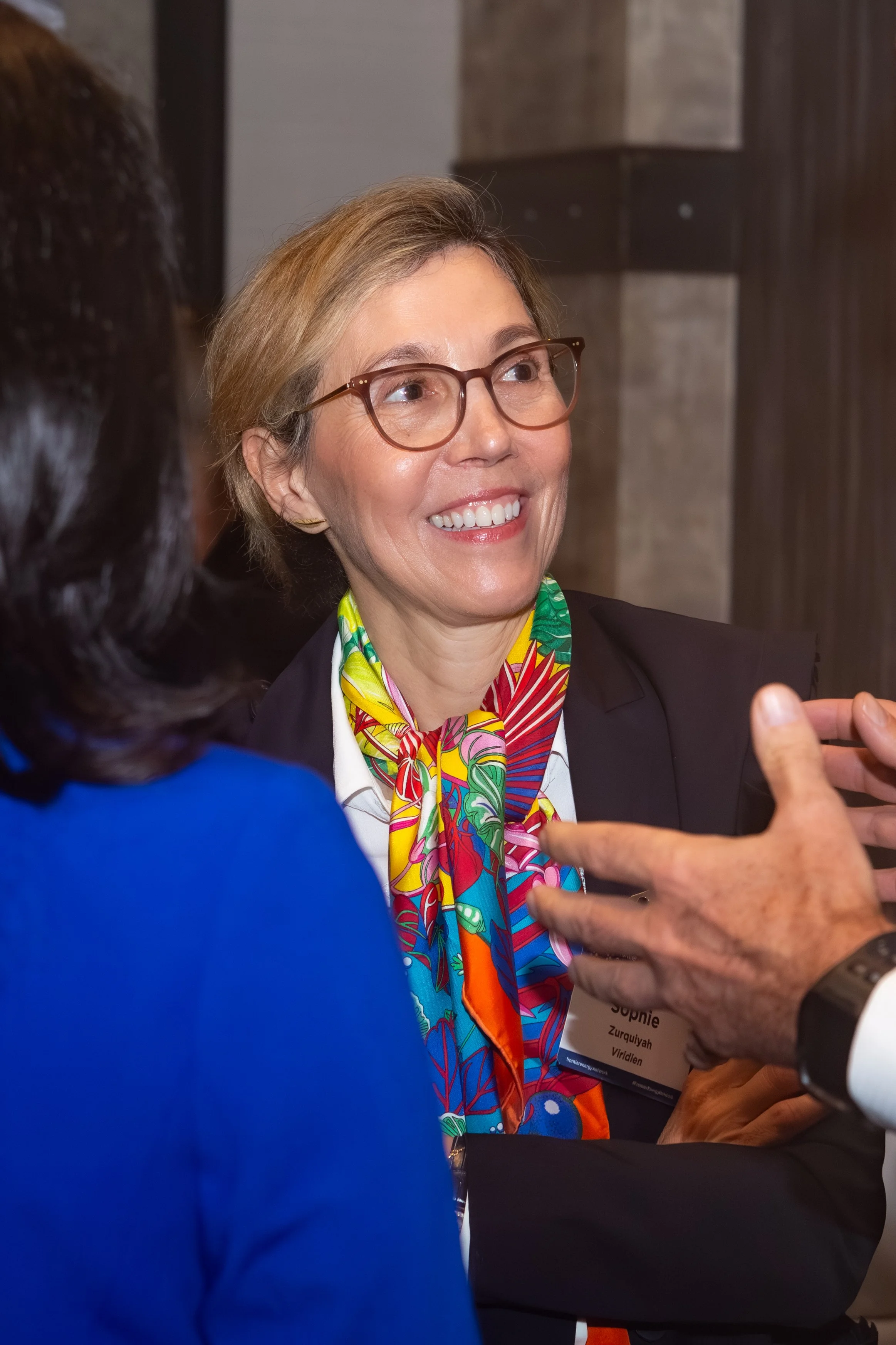Energy industry delegates engaging in conversation at a professional networking reception