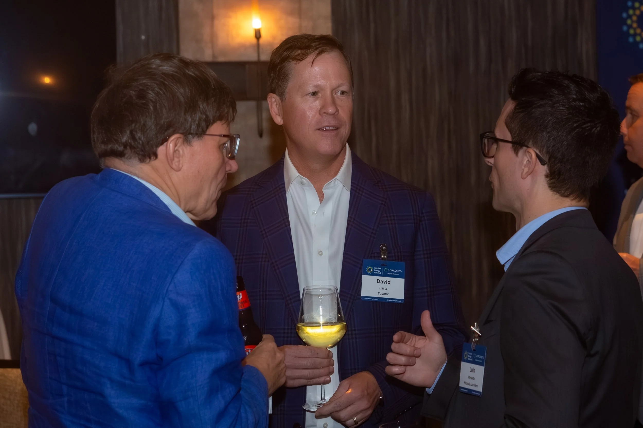 Energy industry executives networking at a Frontier Energy Network event, discussing business opportunities and industry developments.